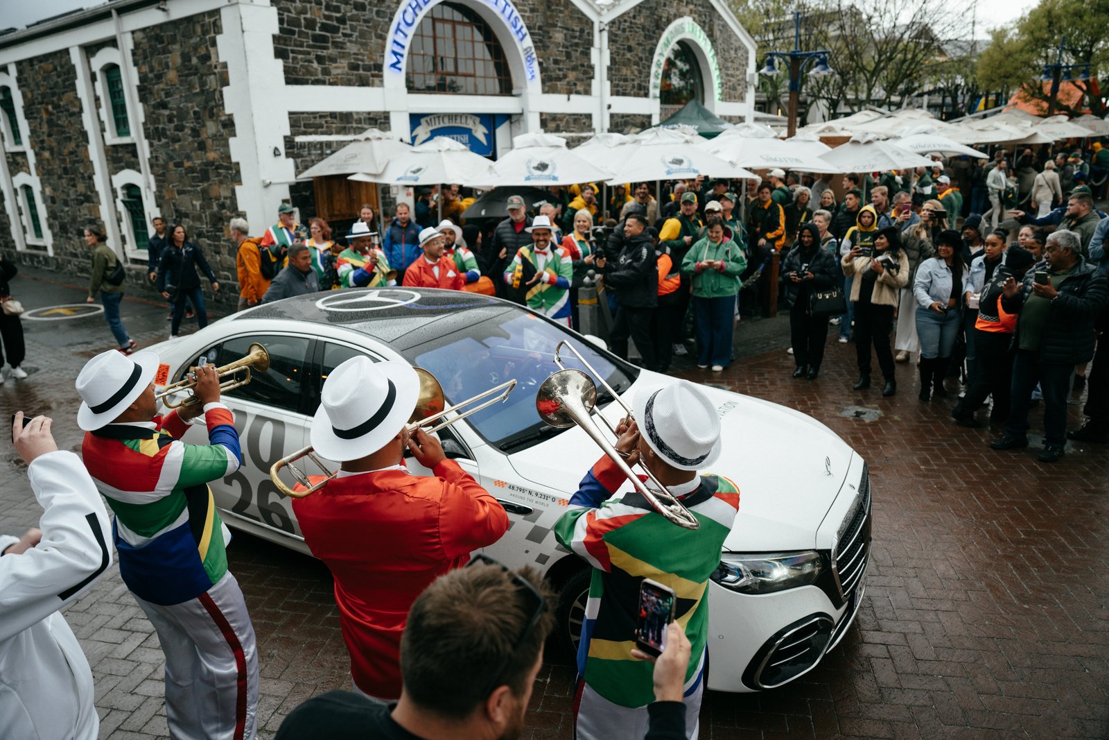 Cape Town minstrels with brass instruments surrounding a Mercedes S-Class