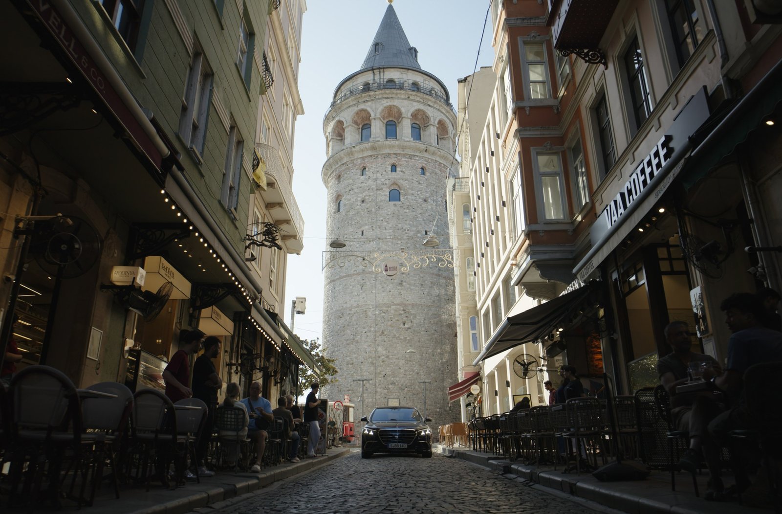Black Mercedes S-Class parked below Galata Tower in Istanbul
