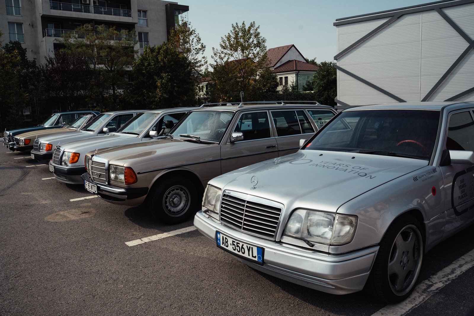 Row of classic Mercedes sedans including a liveried W124 E-Class