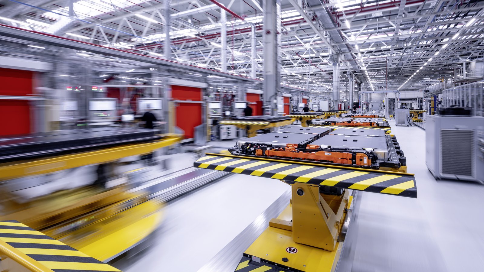High-voltage battery packs on automated carriers at a Mercedes facility