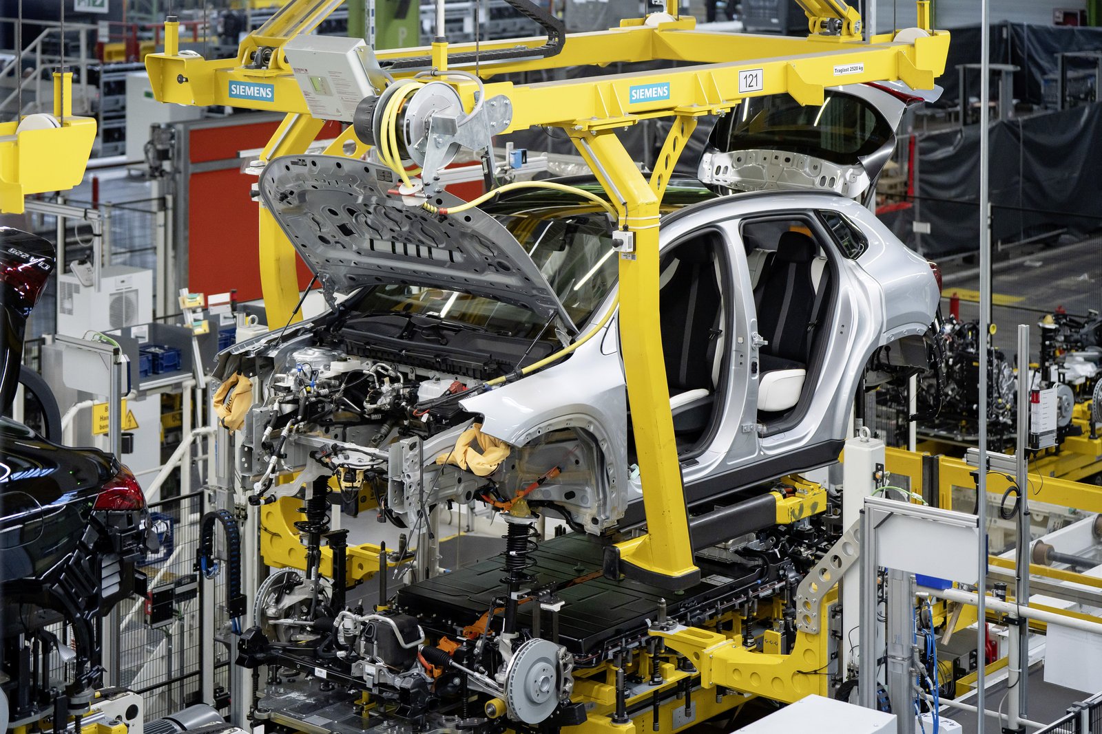Silver Mercedes GLA body lowered onto its chassis at Rastatt