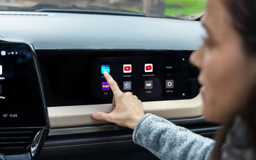 Passenger selecting streaming apps on 2027 Silverado High Country passenger screen