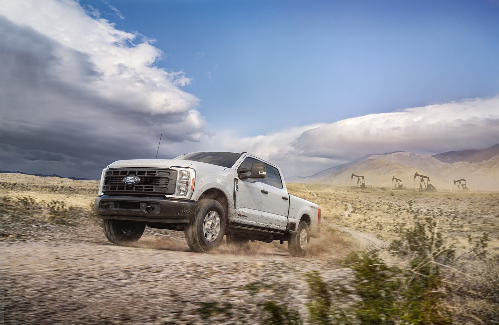 White 2027 Ford Super Duty F-250 XL driving on a dirt road