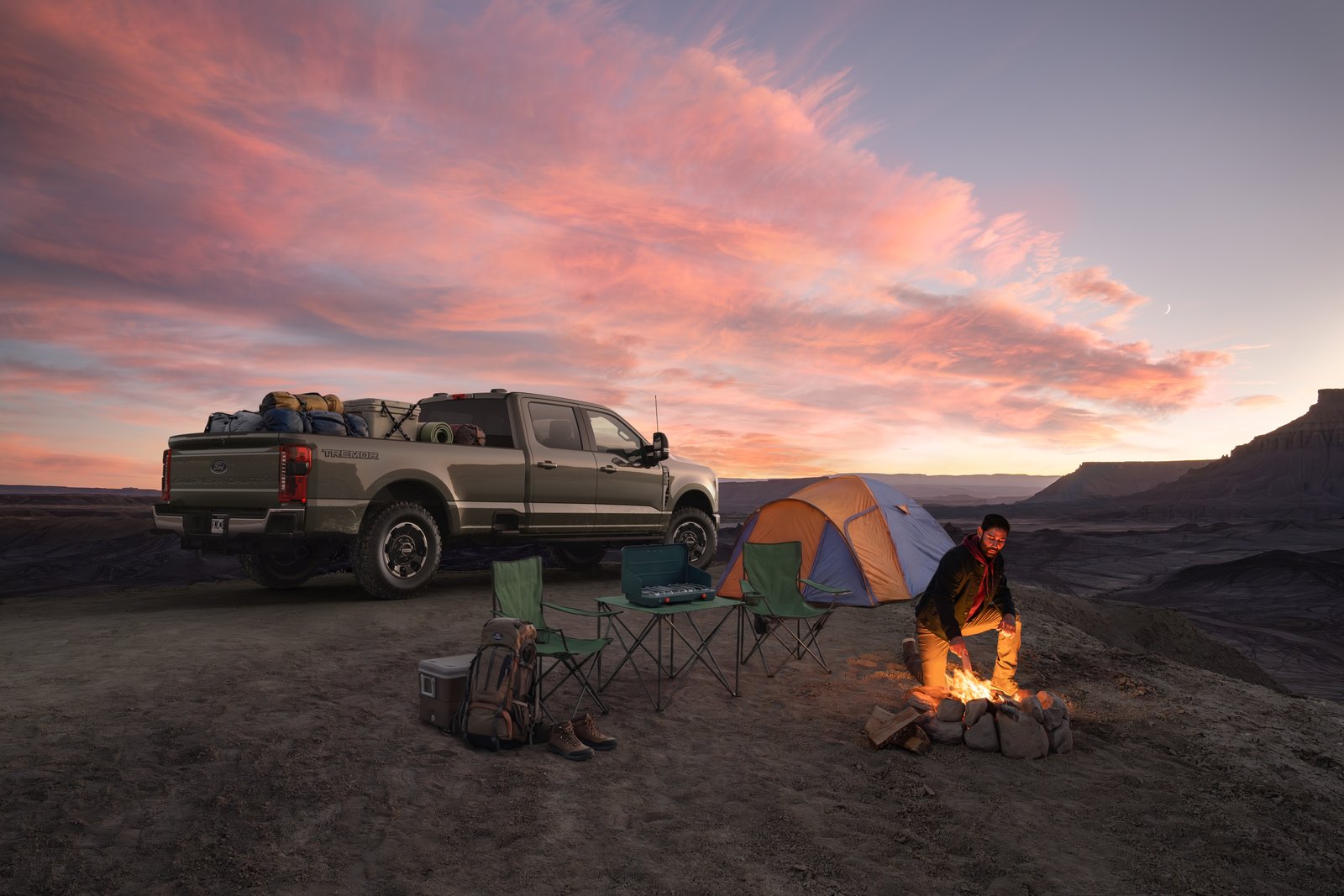 2027 Ford Super Duty F-350 Tremor parked at a desert campsite at dusk