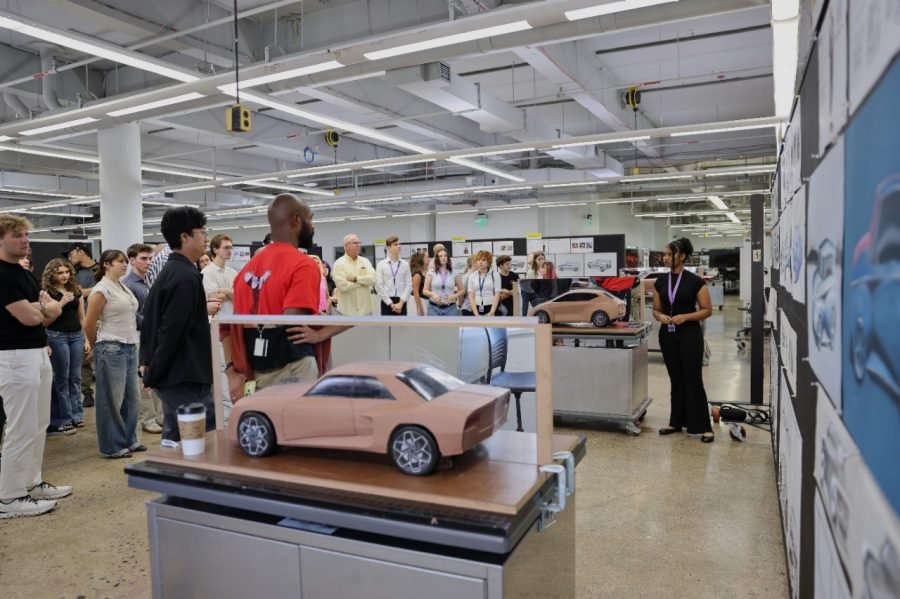 Students review clay car models at College for Creative Studies in Detroit
