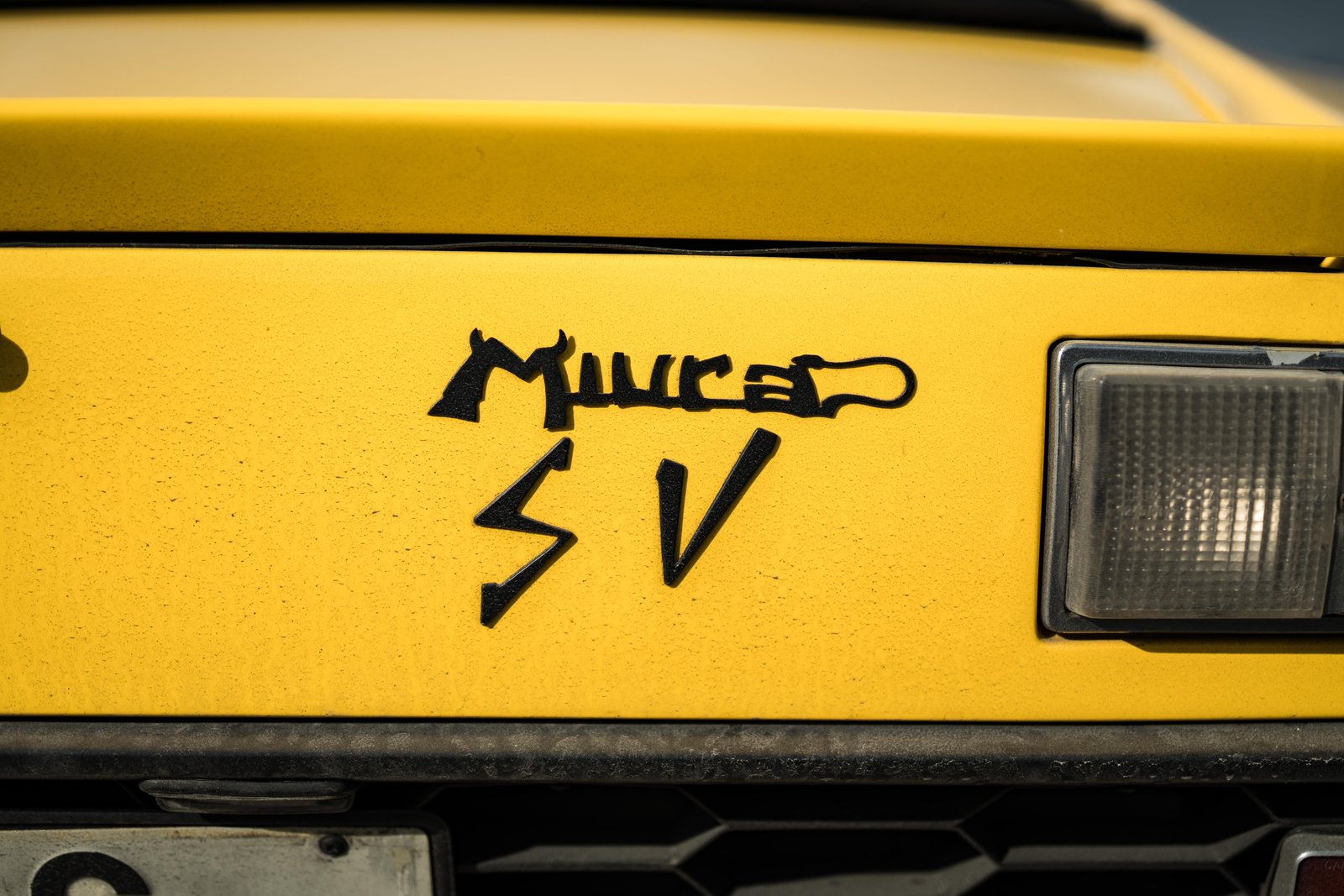 Miura SV badge close-up on yellow bodywork