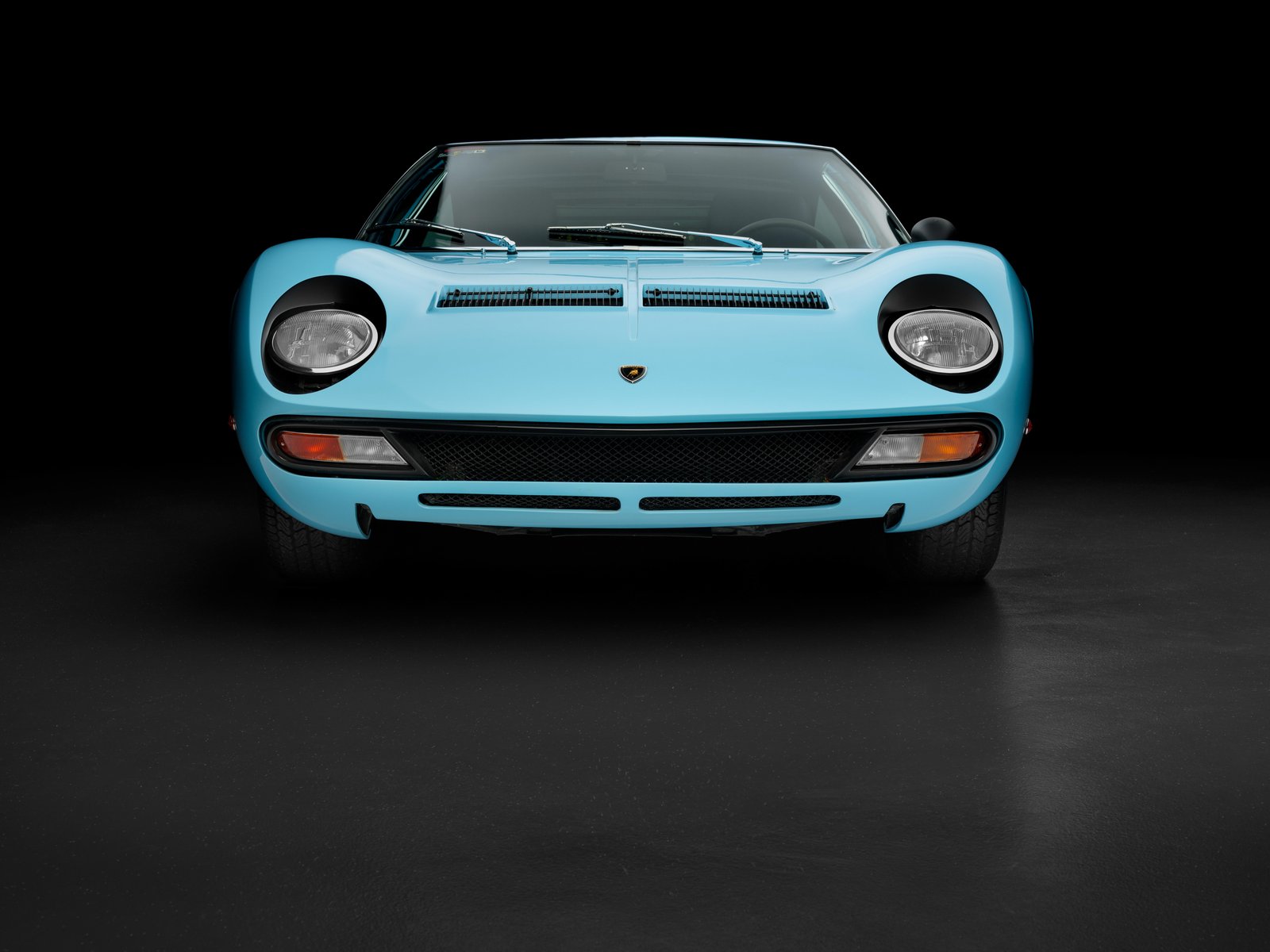Front view of light blue Lamborghini Miura SV without headlight eyelashes