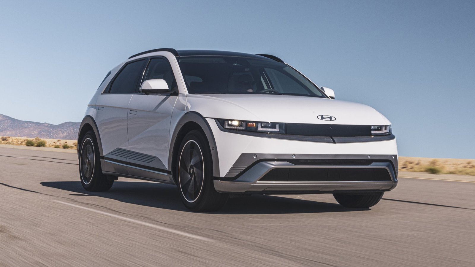 White 2026 Hyundai Ioniq 5 Limited driving on a desert highway
