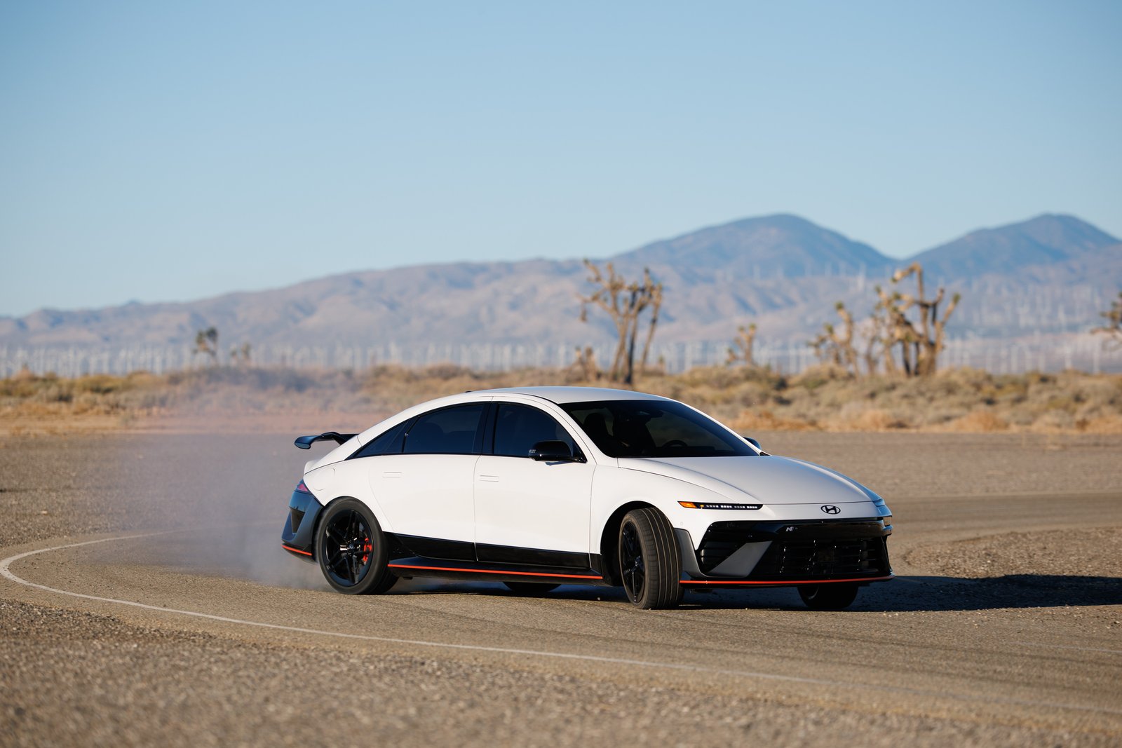 White Hyundai Ioniq 6 N drifting on a desert course