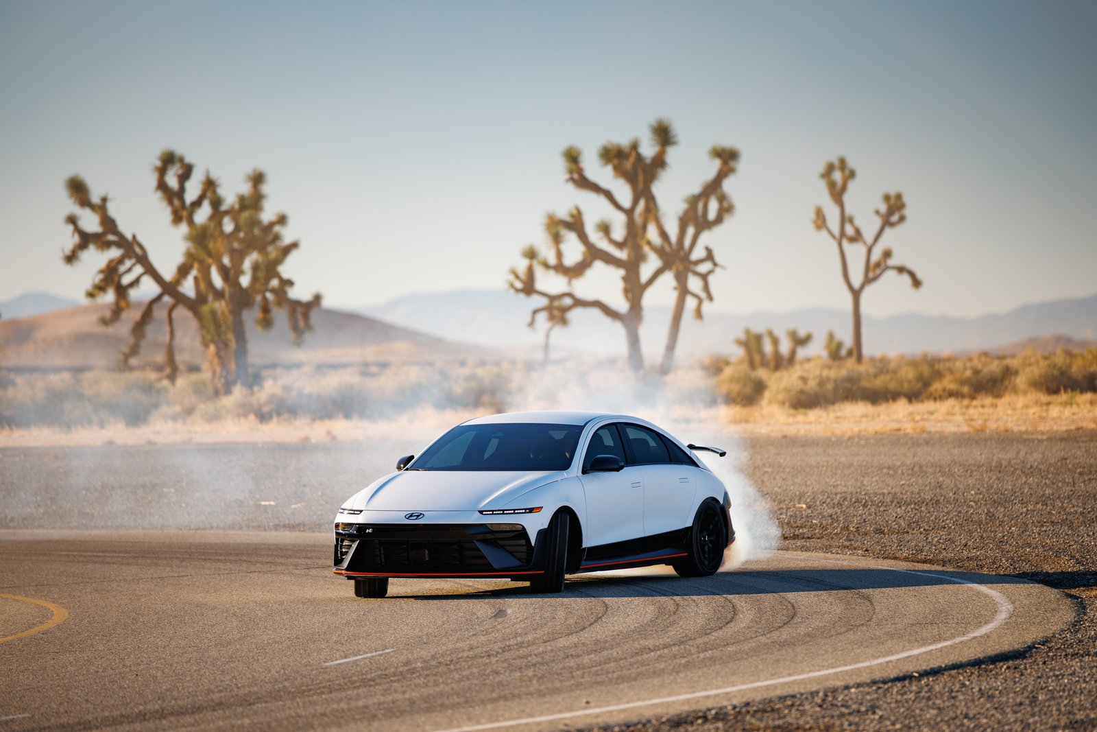 Hyundai Ioniq 6 N sliding through a corner with tire smoke
