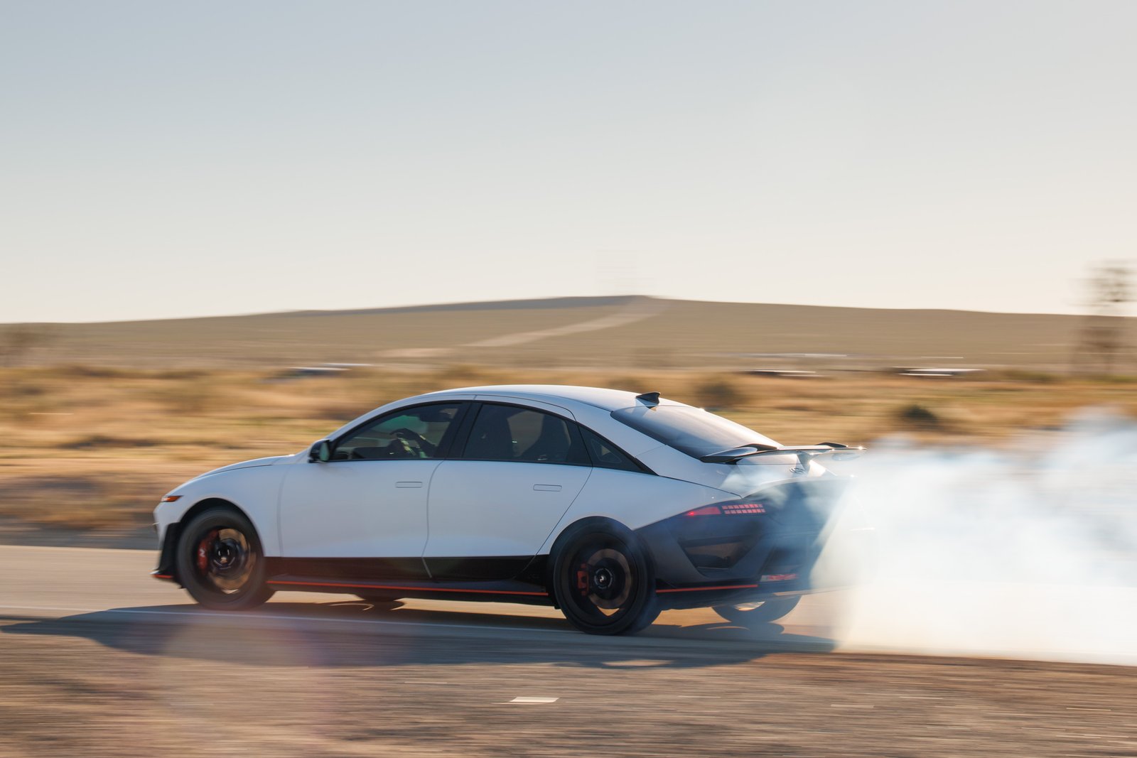 Side view of Hyundai Ioniq 6 N with rear wing and tire smoke