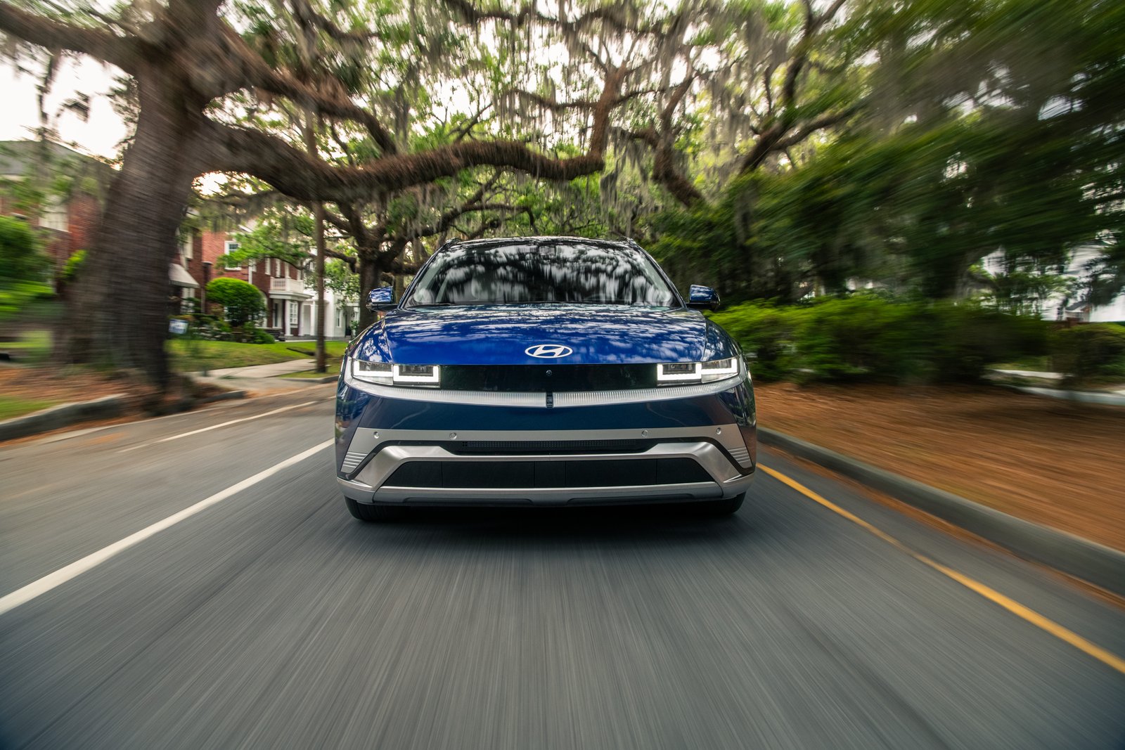 2026 Hyundai Ioniq 5 driving on a tree-lined street