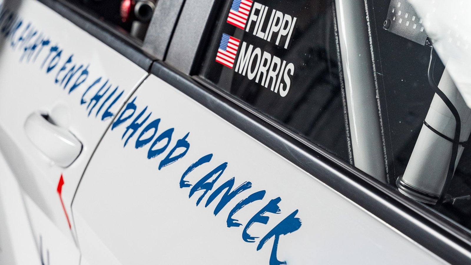 Hand-painted childhood cancer message on Hyundai race car door