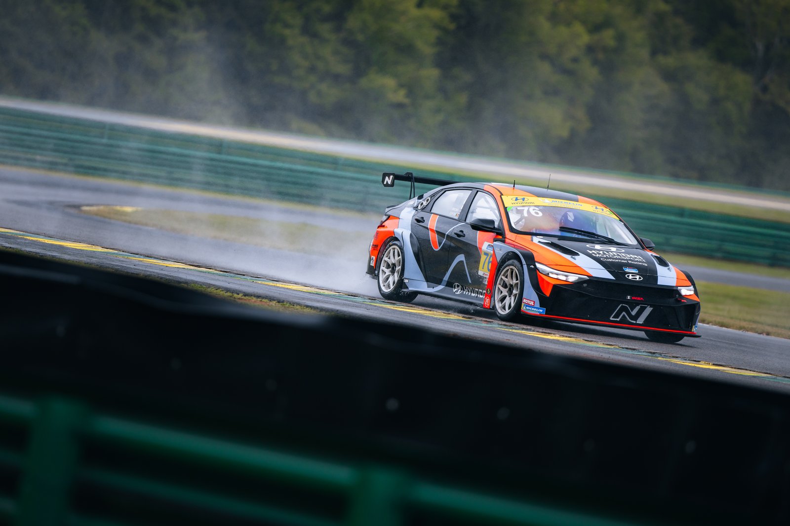 No. 76 Hyundai Elantra N TCR racing in wet conditions at VIR