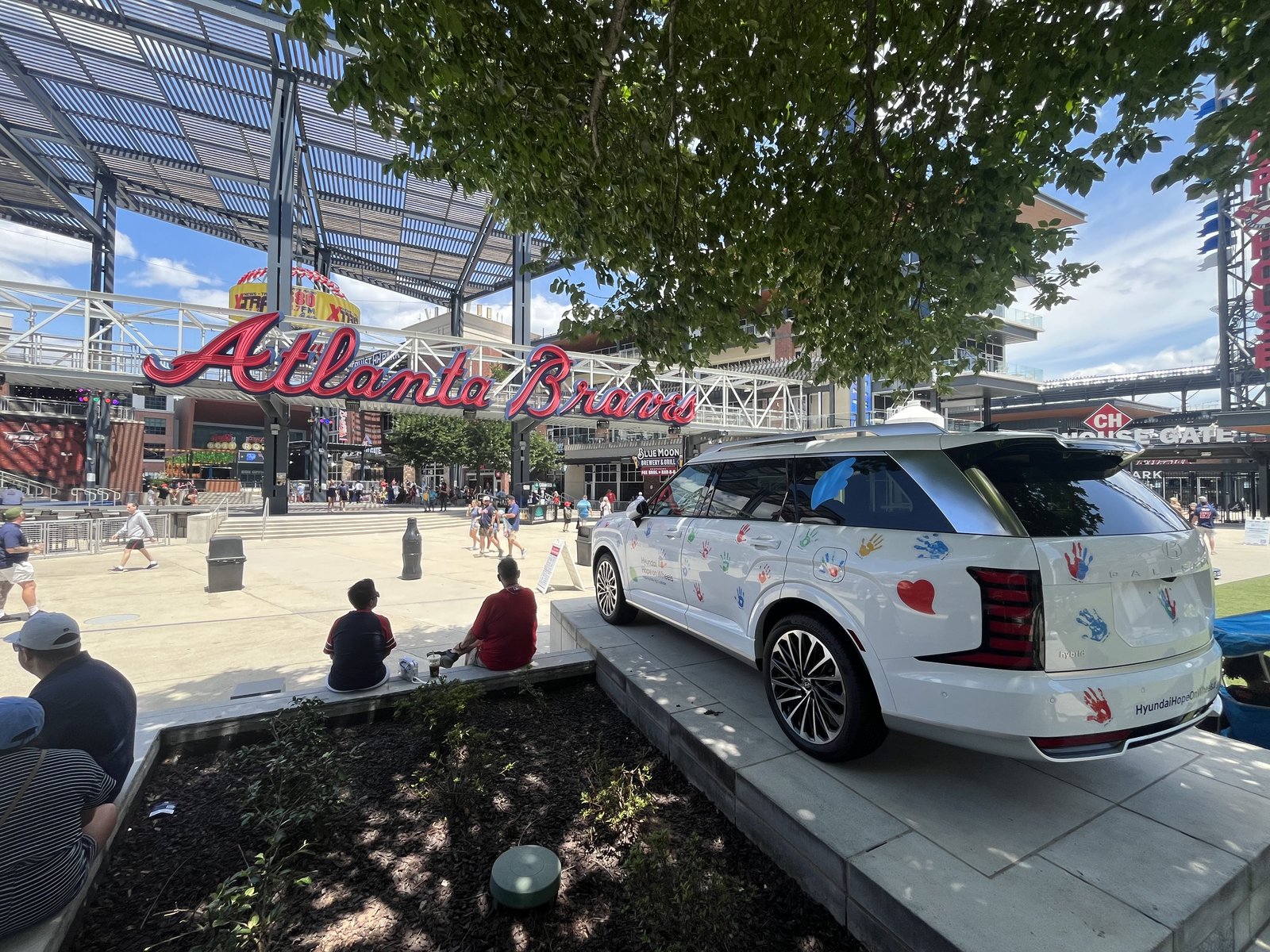 Handprint-covered Hyundai Palisade Hybrid under the Atlanta Braves sign