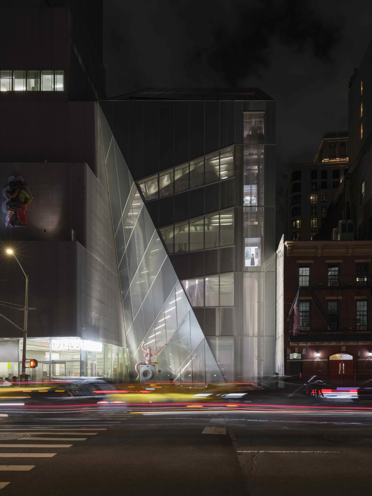 New Museum facade on the Bowery at night with lit elevator