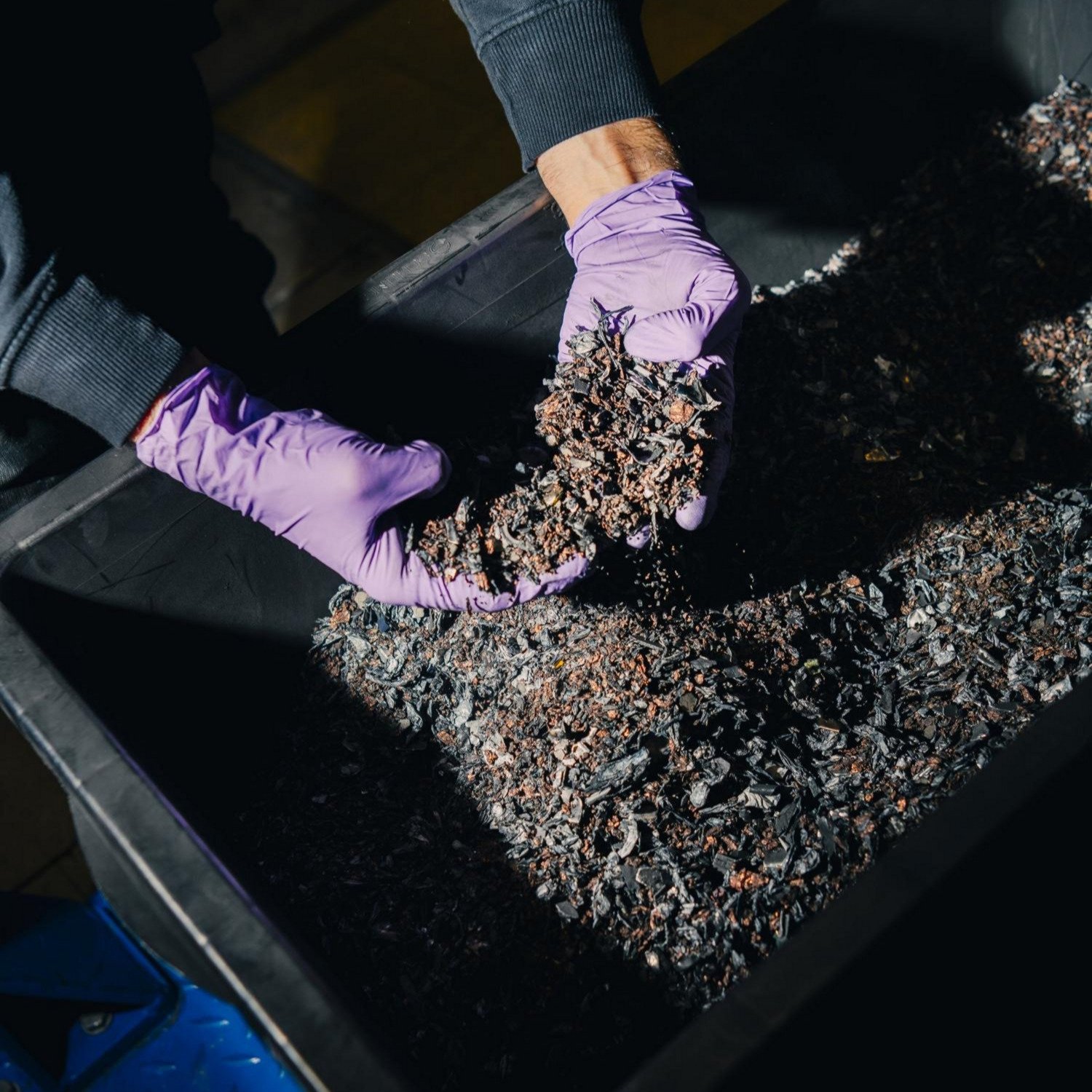 Shredded Porsche EV battery material with visible copper fragments