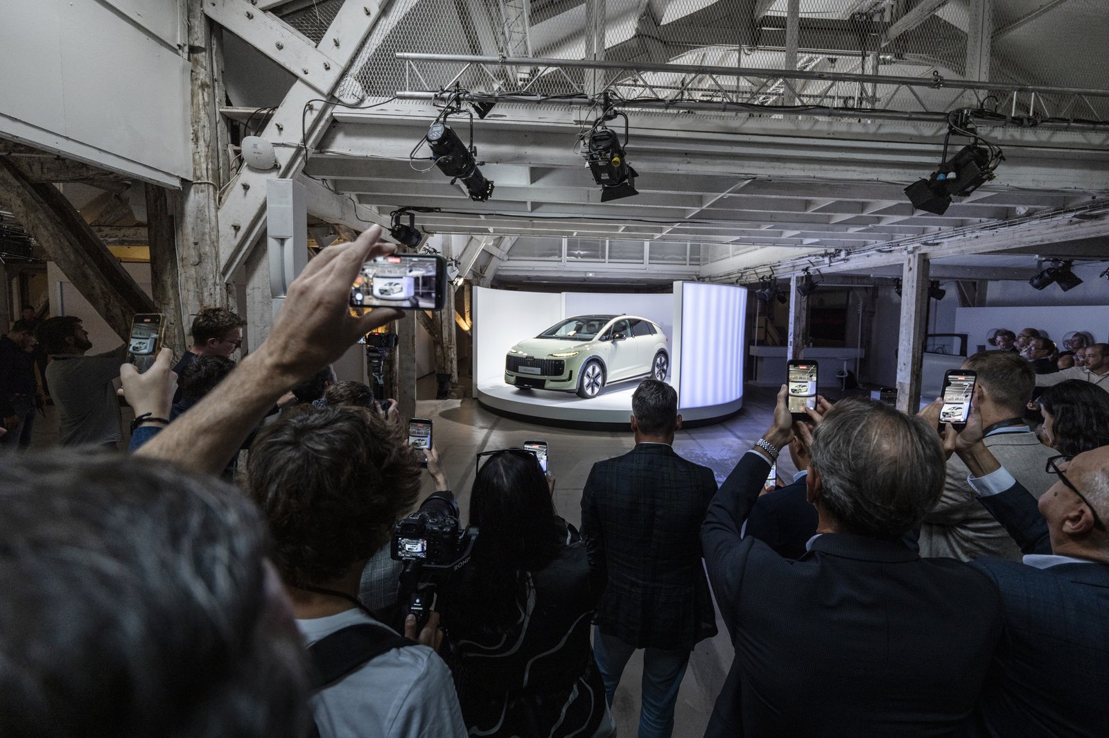 Journalists photograph the Audi A2 e-tron at its Paris reveal
