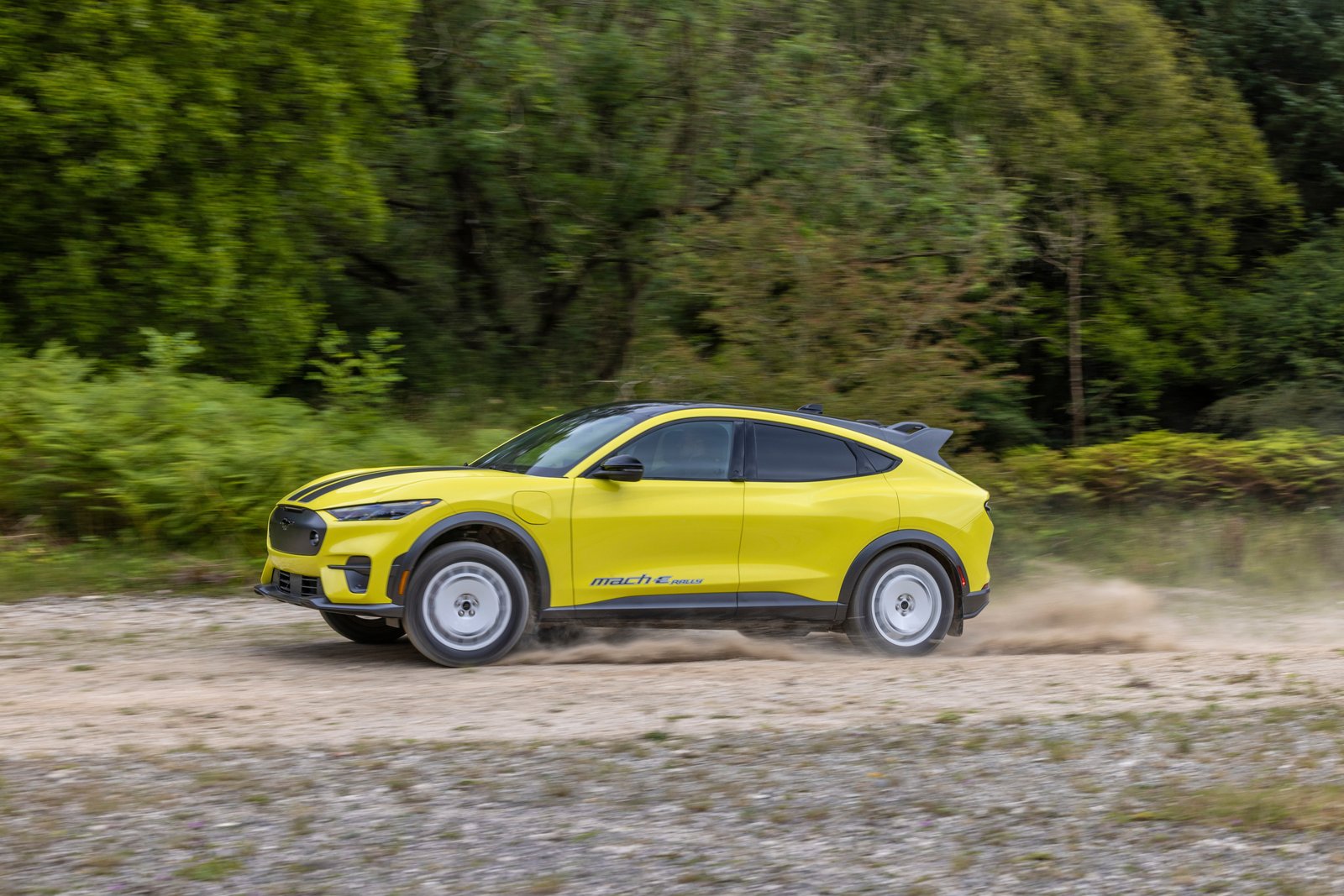 Ford Mustang Mach-E Rally driving fast on a dirt road