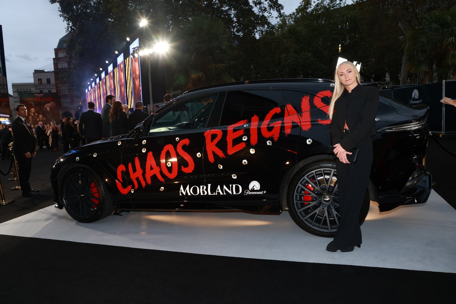 Side view of Chaos Reigns Aston Martin DBX at evening MobLand premiere