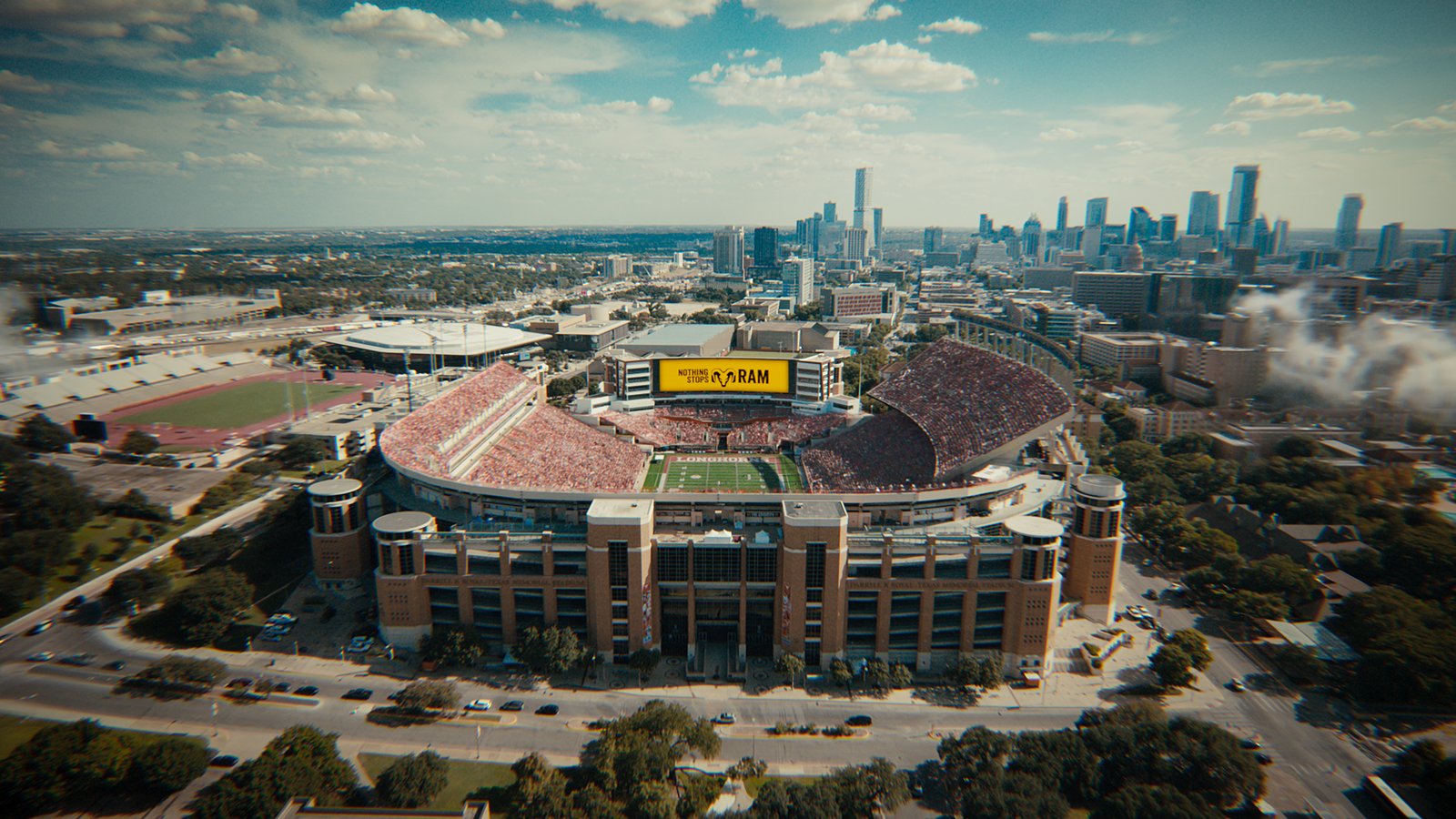 Aerial view of Texas football stadium with Nothing Stops Ram scoreboard branding