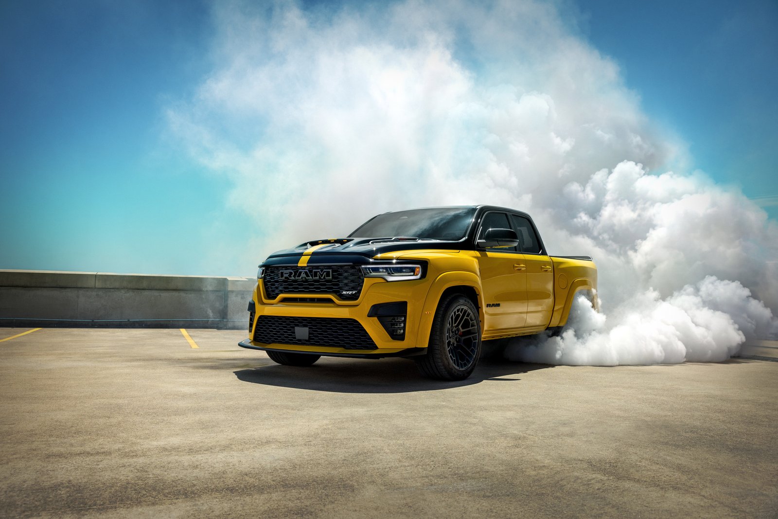 Yellow and black Ram 1500 with SRT badging performing a burnout