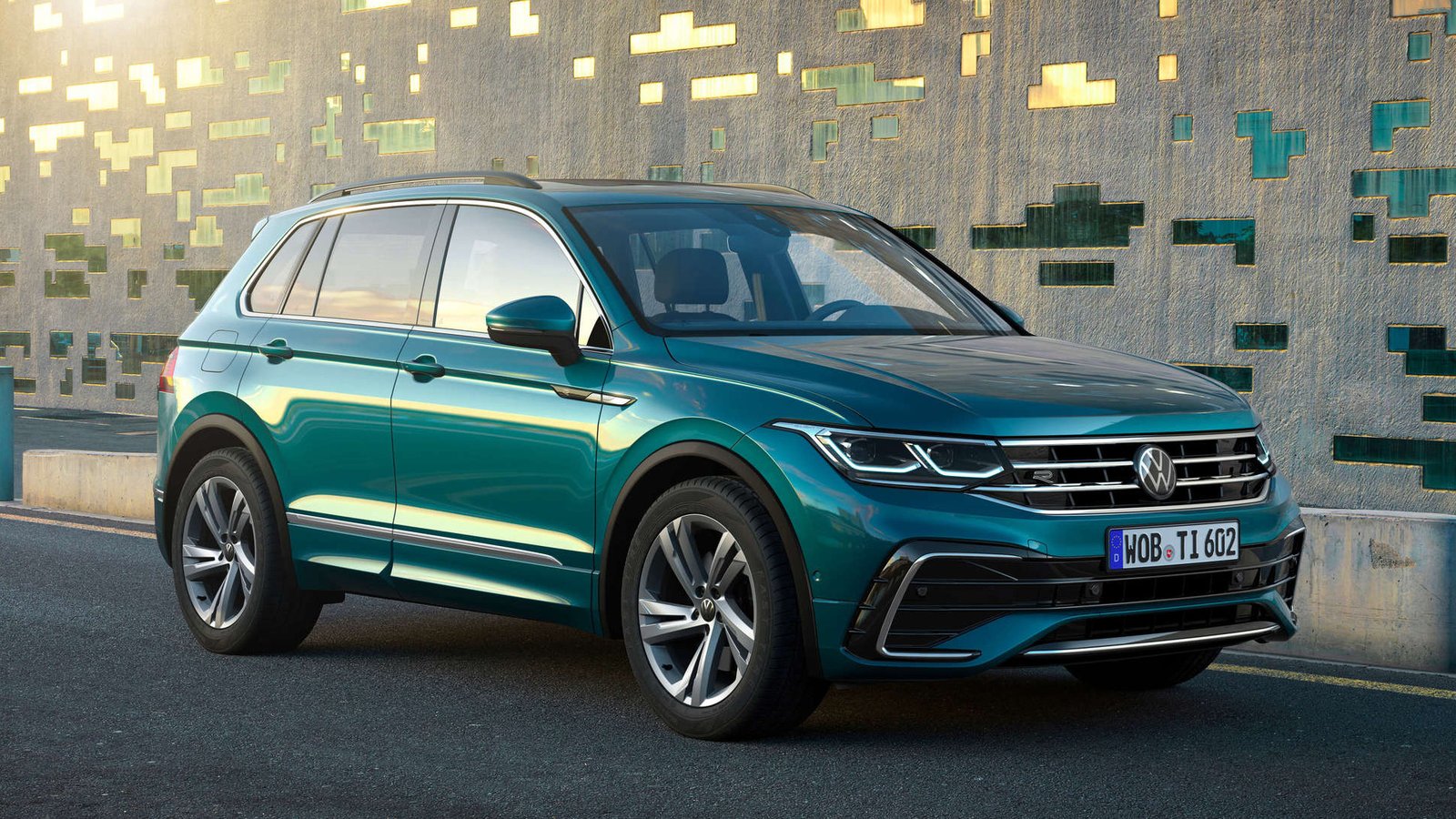 Teal Volkswagen Tiguan R-Line parked in front of a mosaic wall