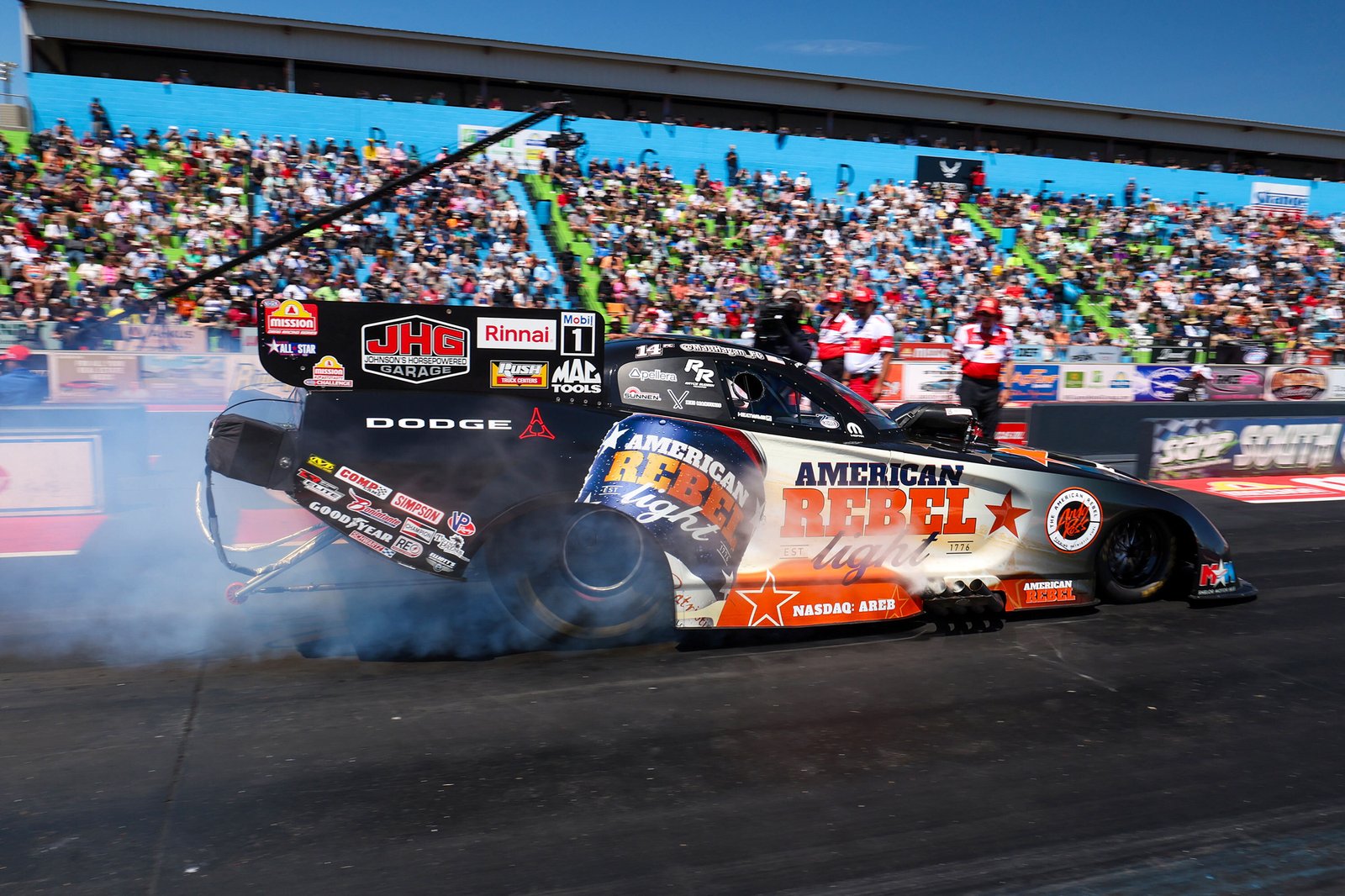 Hagan's Dodge Funny Car performs burnout in front of packed grandstands