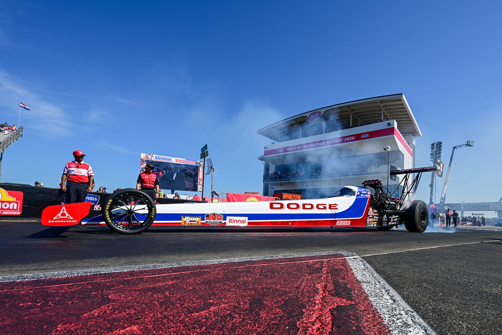 Leah Pruett's Dodge Top Fuel dragster during burnout at the starting line