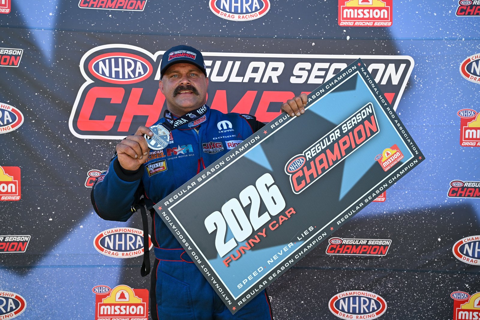 Matt Hagan holding the 2026 NHRA Funny Car regular season champion sign