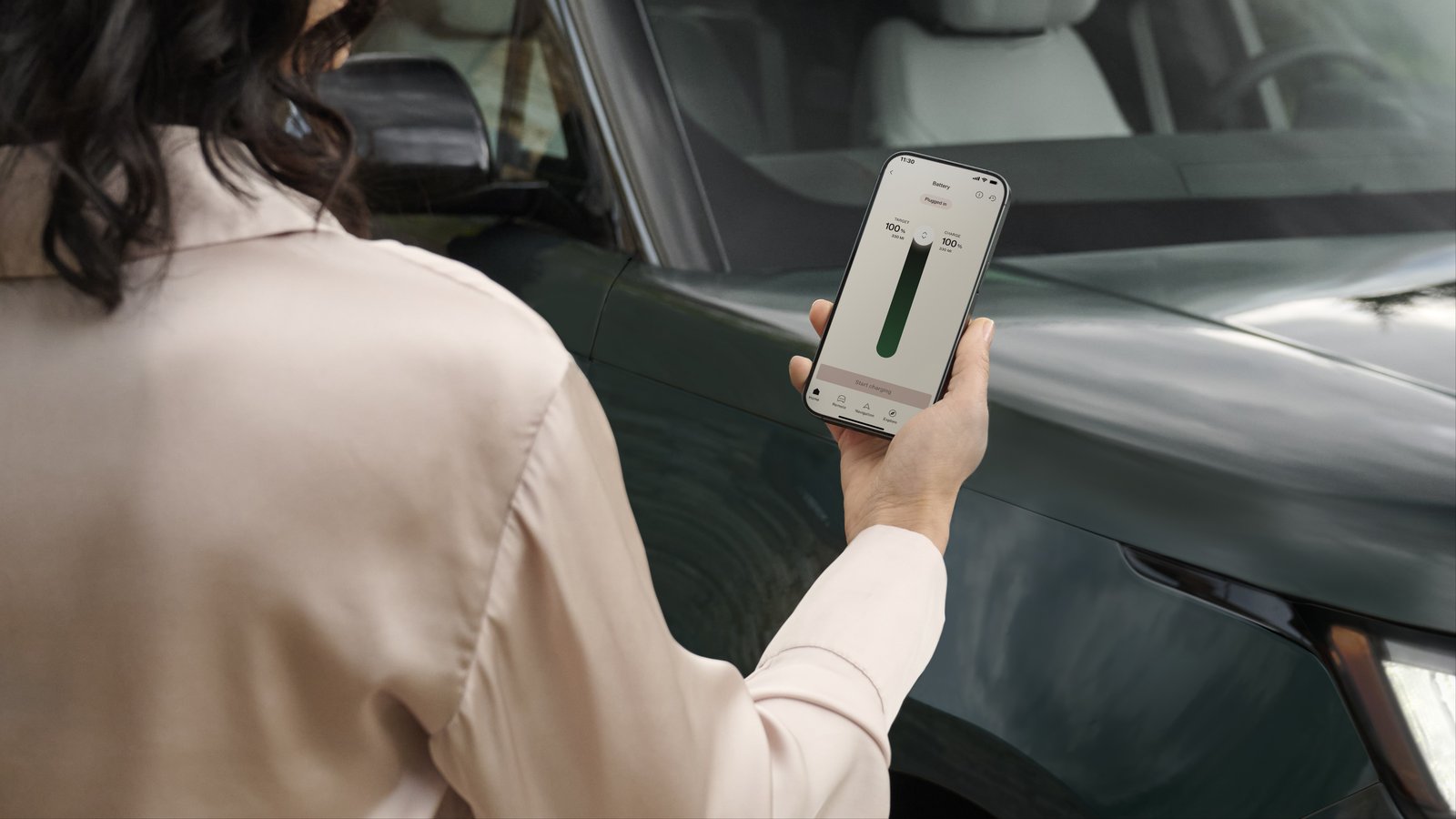 Owner checking Range Rover Electric charge status in smartphone app