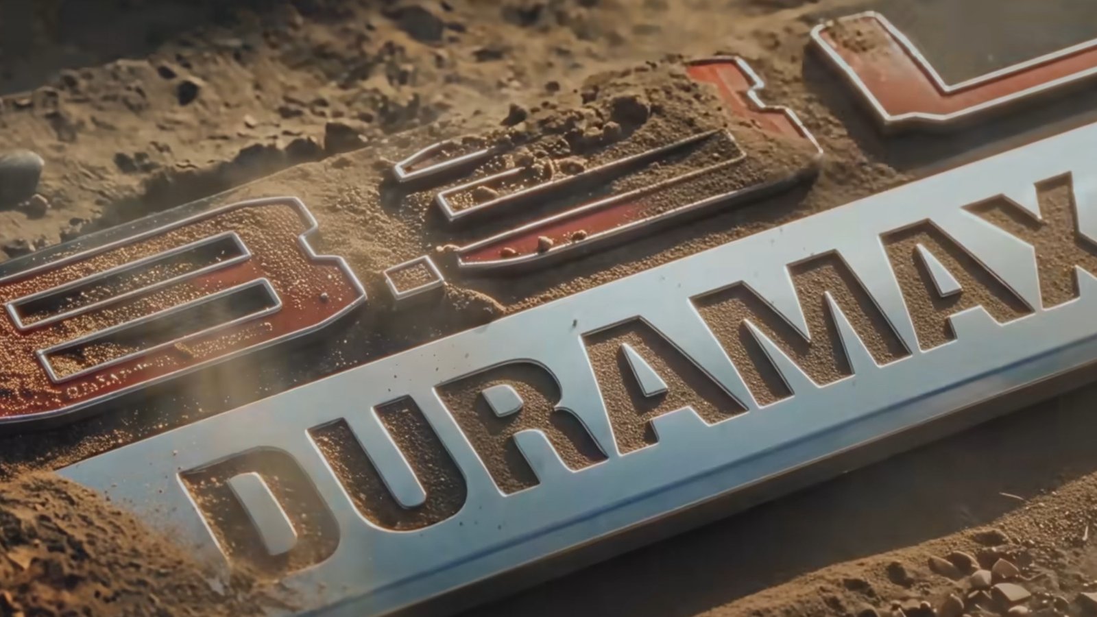 Dirt-covered 8.3L Duramax badge revealed at the end of GM's teaser
