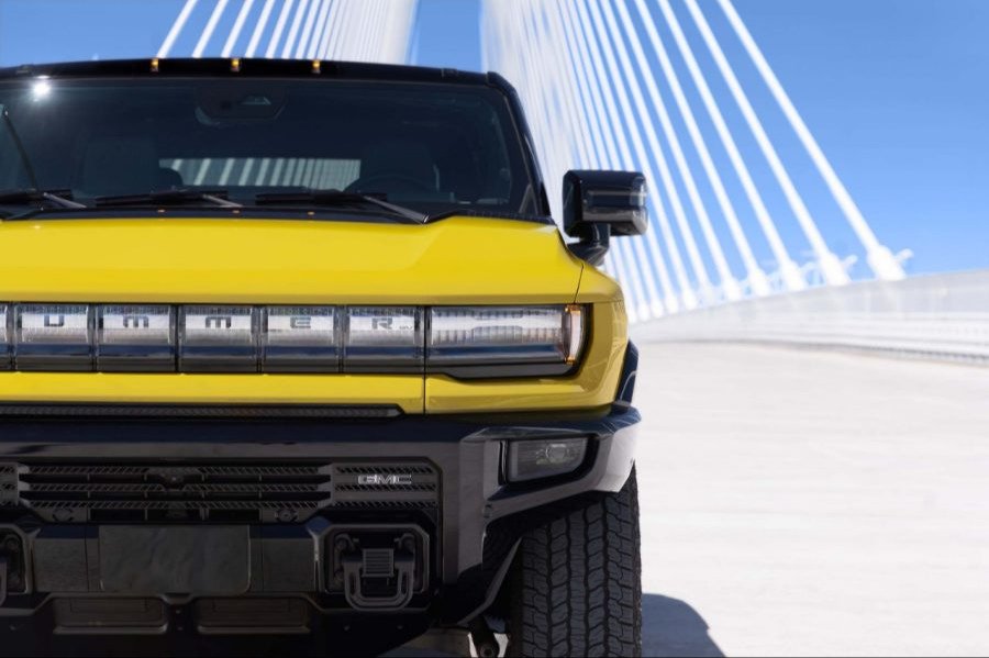 Close-up of the illuminated HUMMER lettering on a yellow GMC HUMMER EV