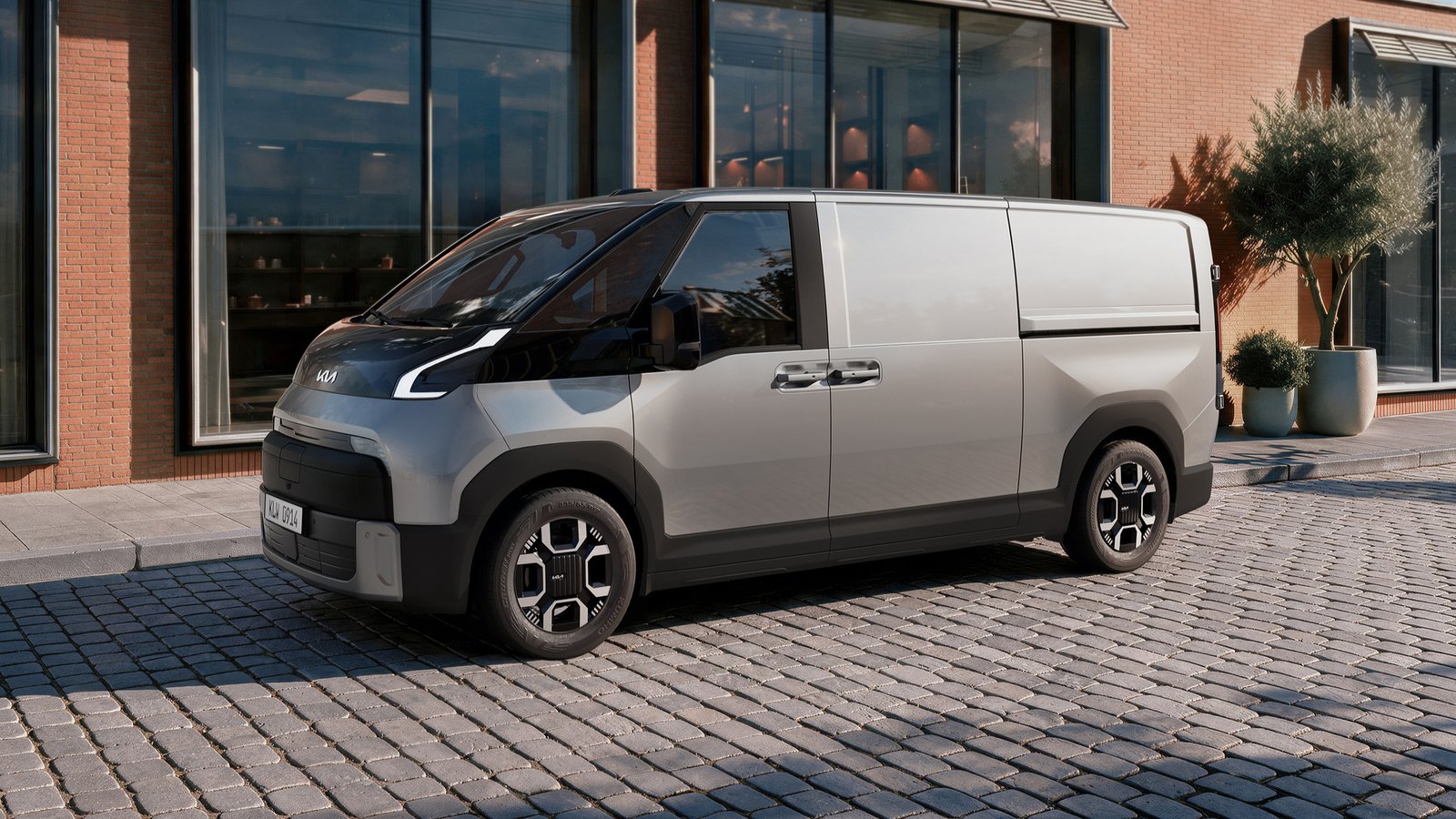 Silver Kia PV7 Cargo electric van, front three-quarter view on cobblestones
