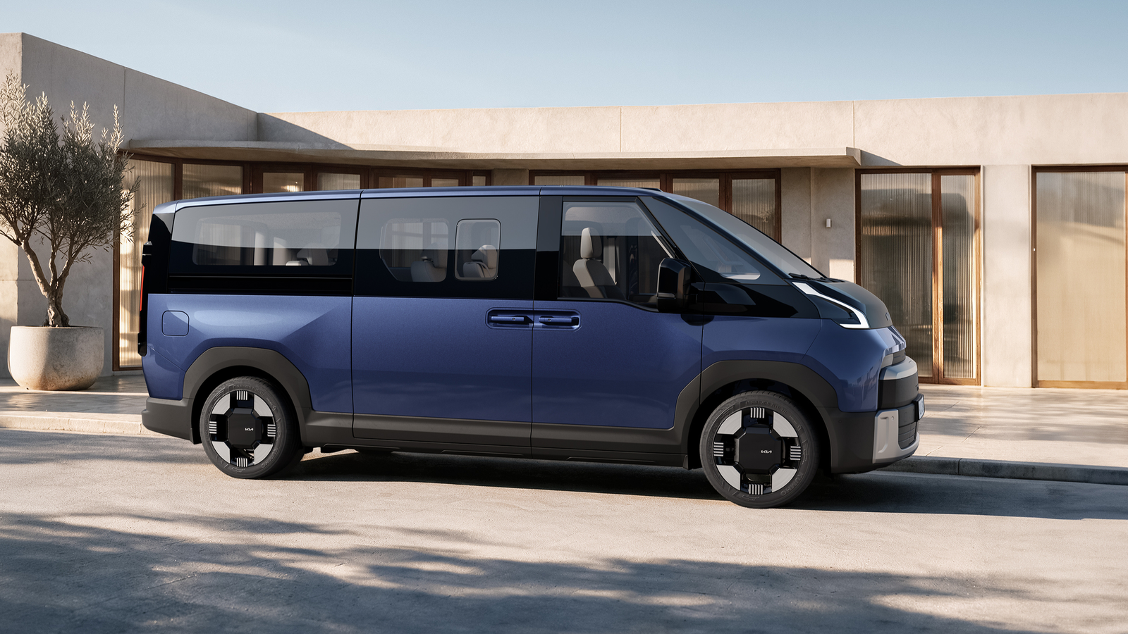 Blue Kia PV7 Passenger electric van in side profile