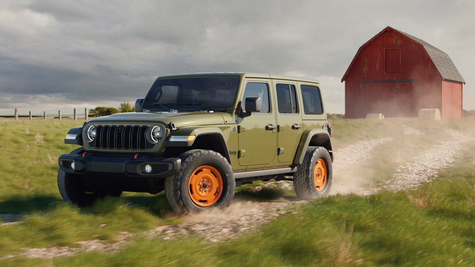 Four-door 2027 Jeep Wrangler JL-2A in '41 green beside a red barn