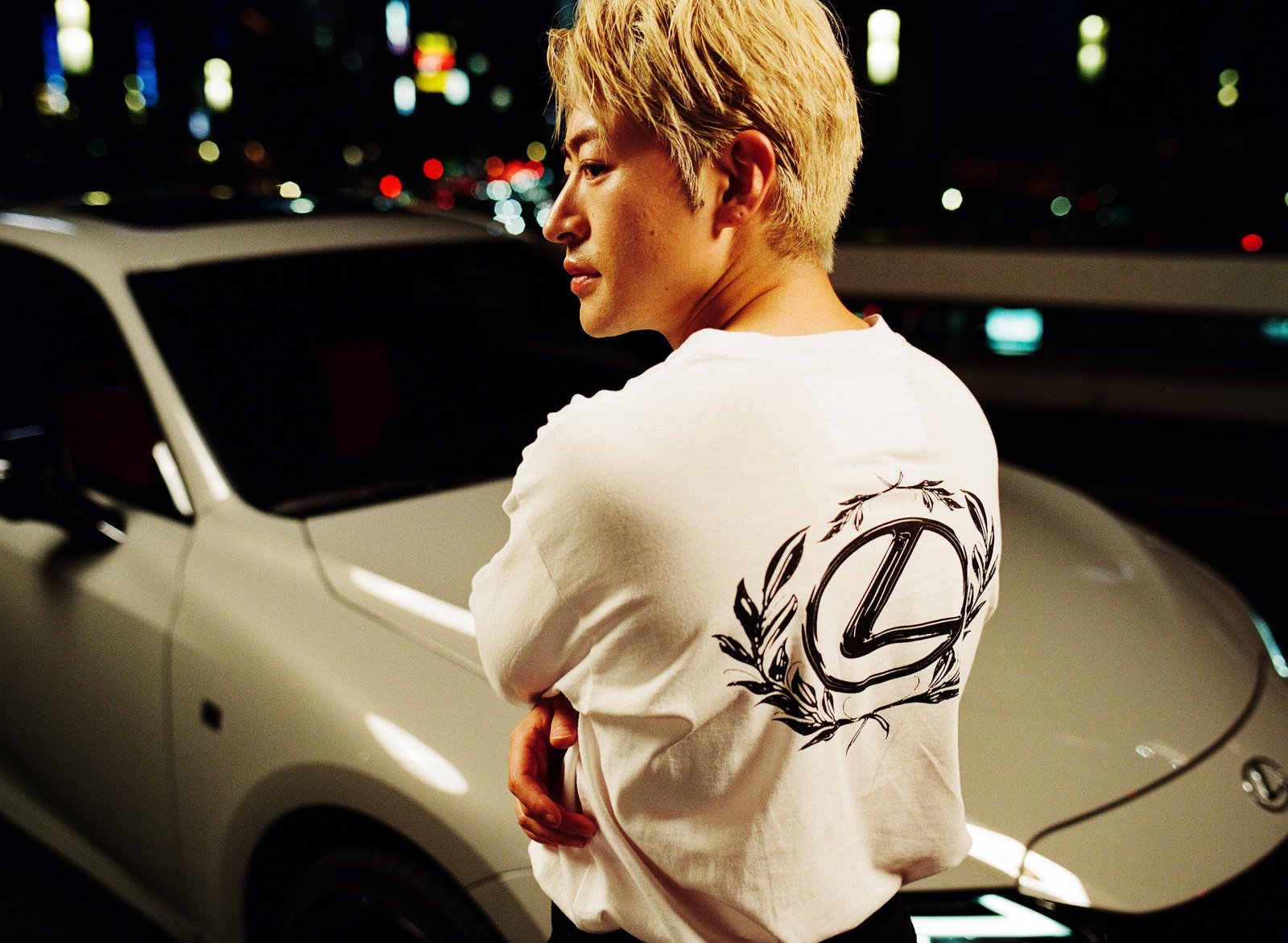 Reo Sano in white Lexus AMBUSH long-sleeve tee by white IS at night