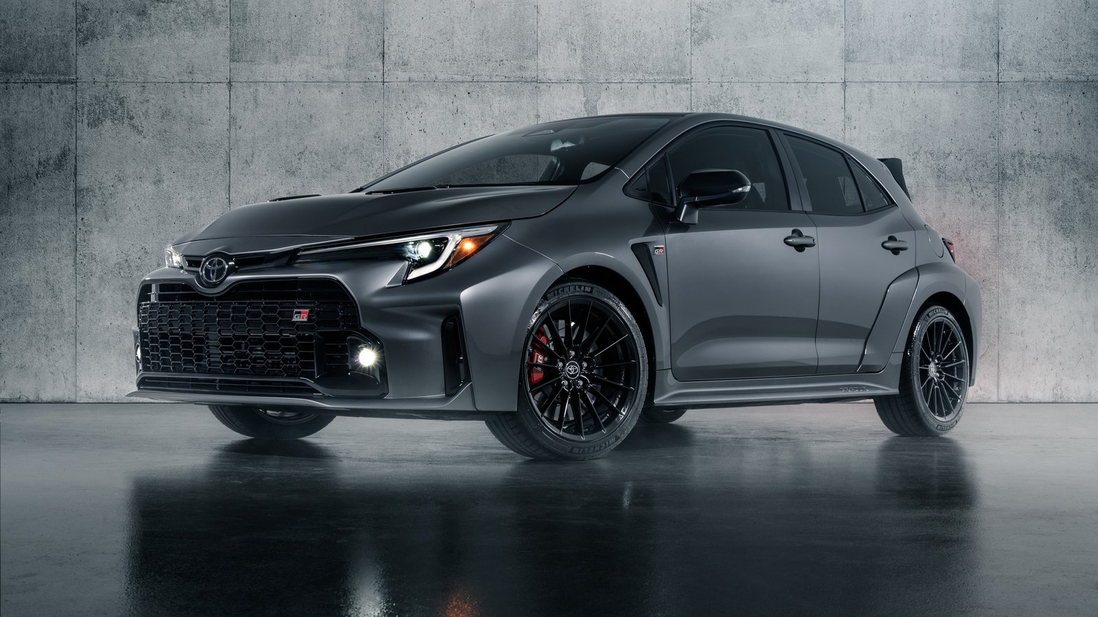 Gray Toyota GR Corolla hatchback in a concrete studio