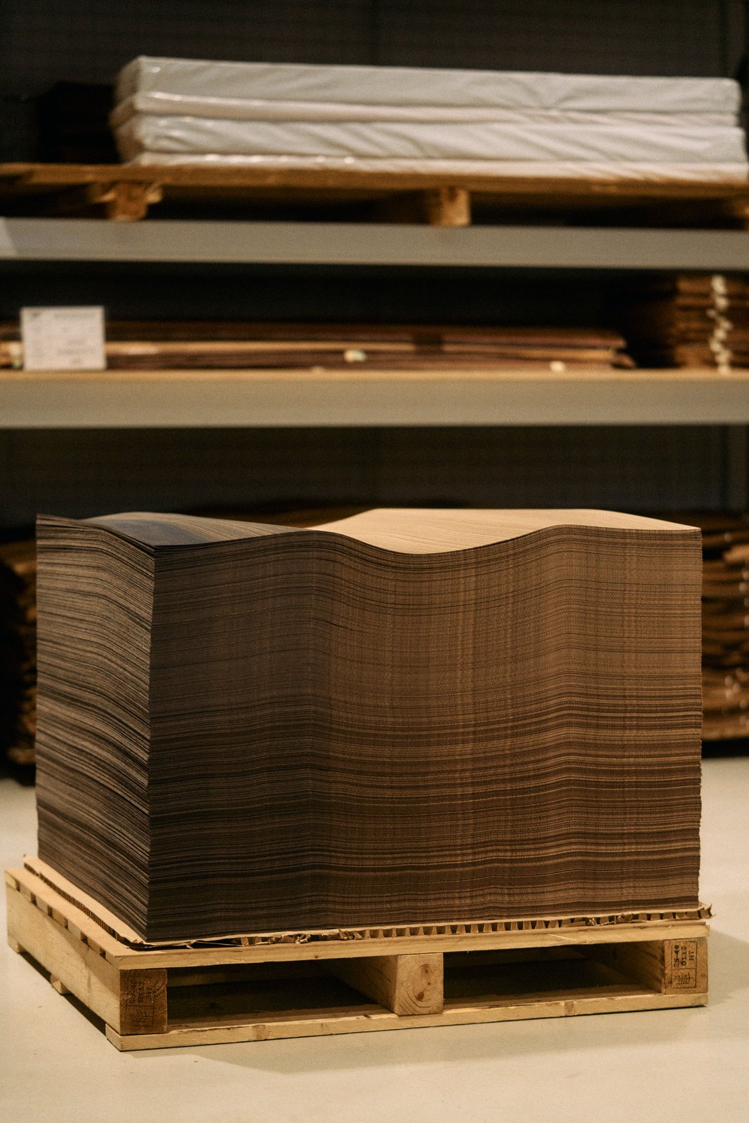 Stack of wood veneer sheets on a pallet at Bentley's Crewe factory