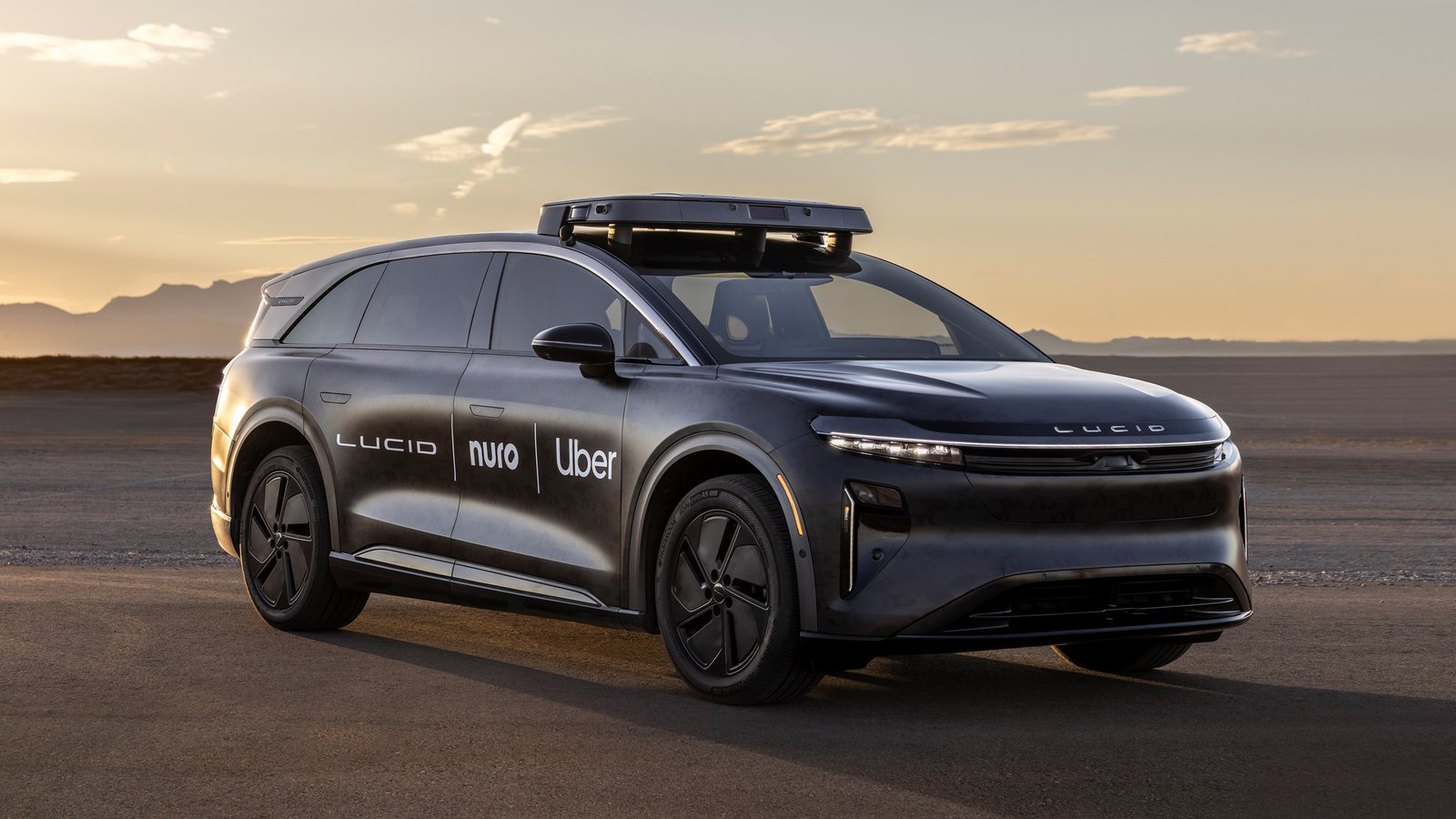 Lucid Gravity robotaxi with roof sensor pod and Lucid, Nuro, Uber logos