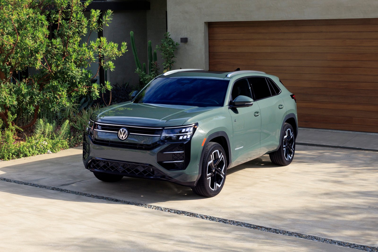 2027 Volkswagen Atlas Cross Sport in Dark Sage parked in a driveway