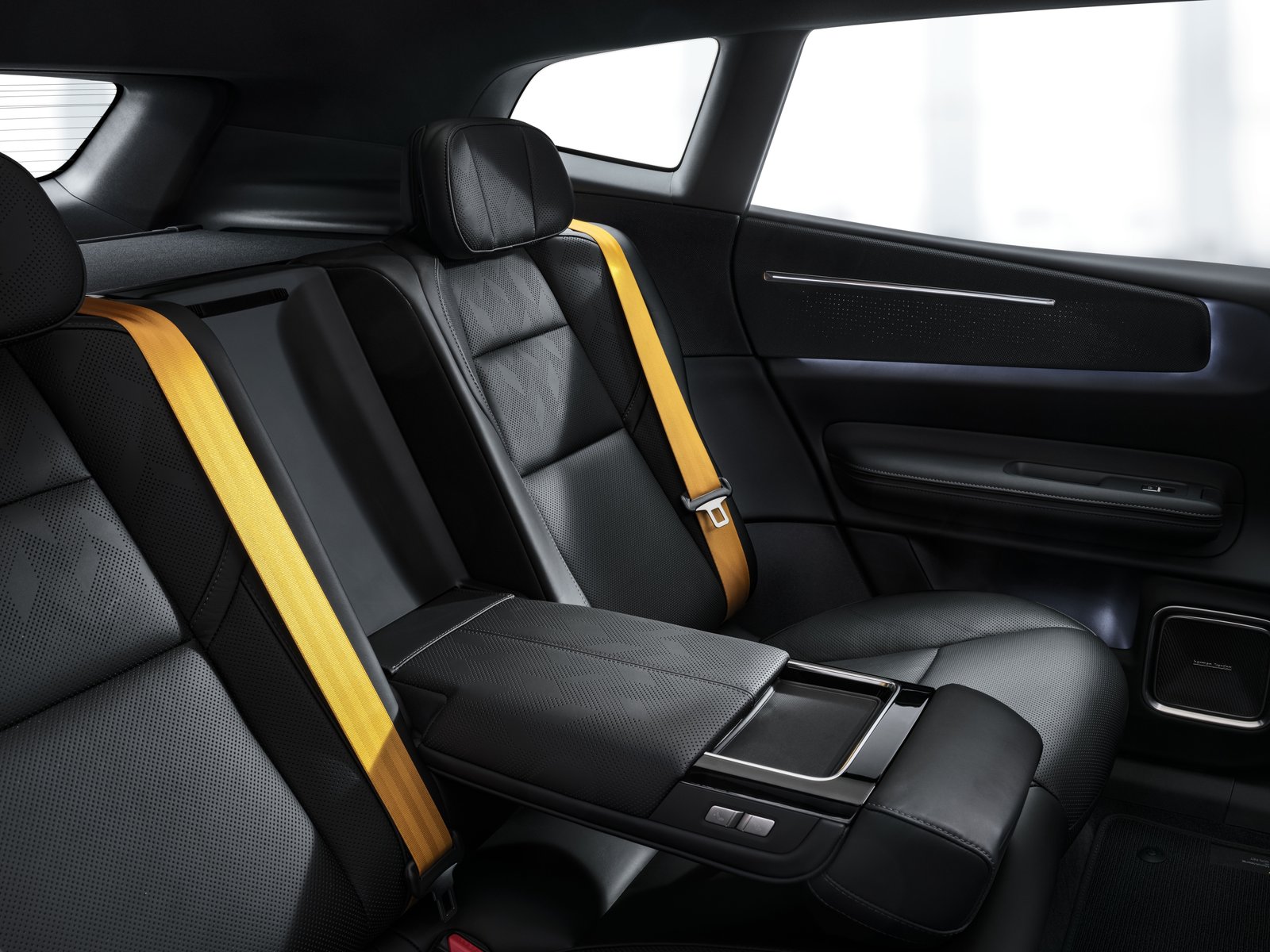 Polestar 4 SUV rear seats with gold seatbelts and fold-down armrest
