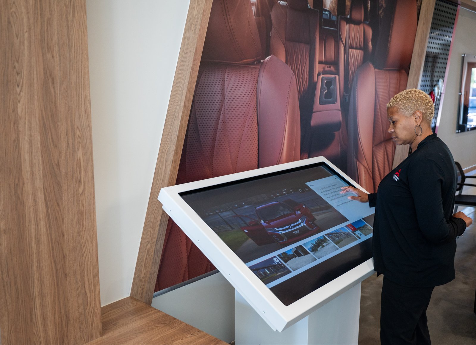 Product specialist using touchscreen configurator inside Mitsubishi Gallery showroom