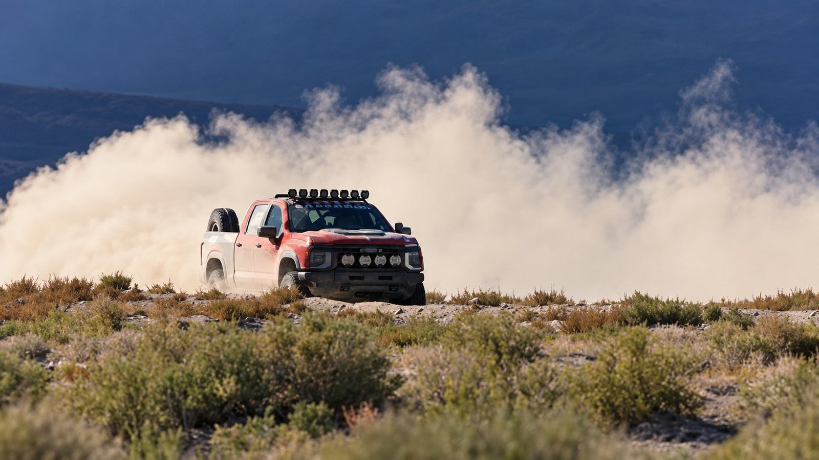 Front view of 2027 Silverado ZR2 racing through dust in Nevada