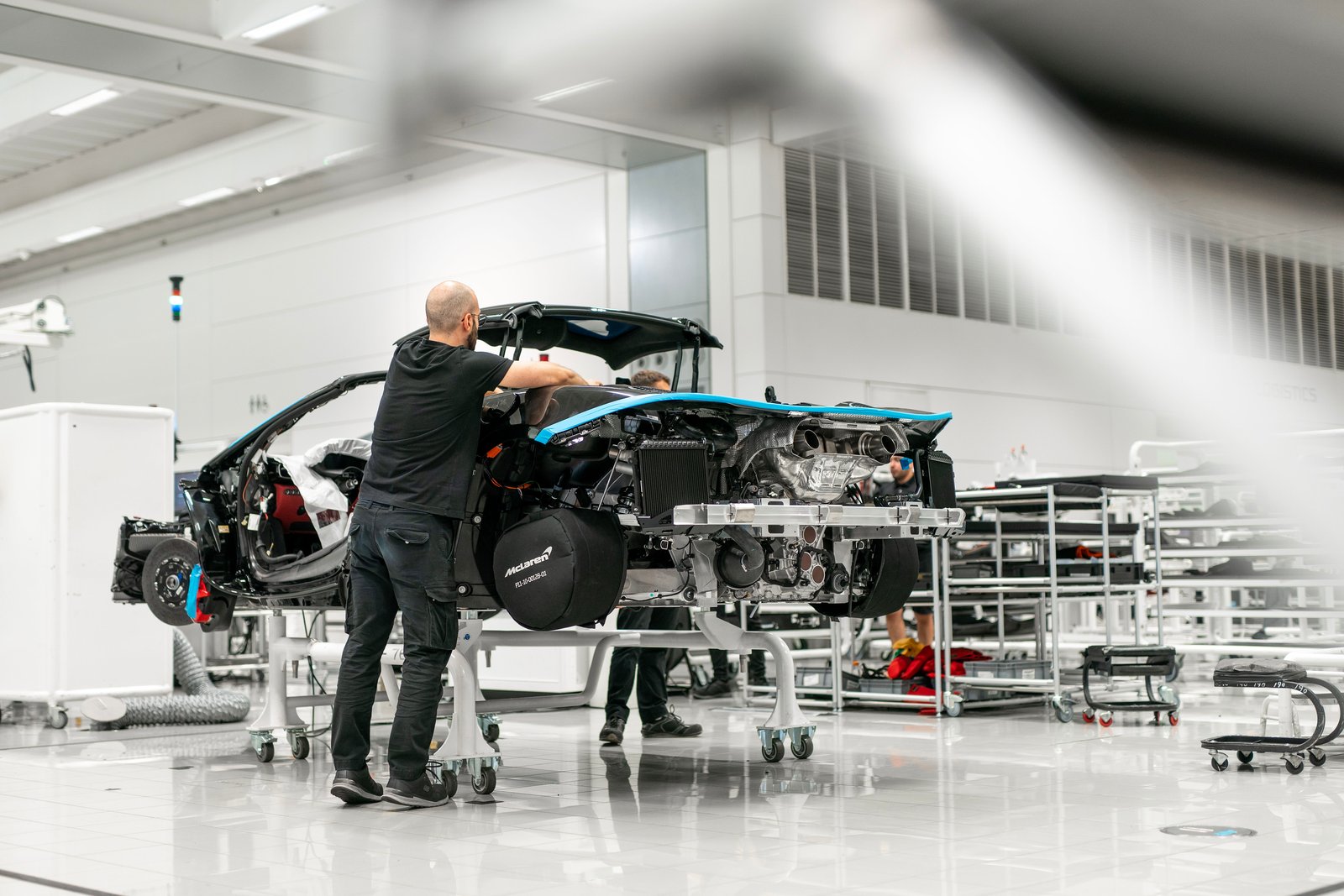 Technicians assembling a McLaren supercar at the Woking production line