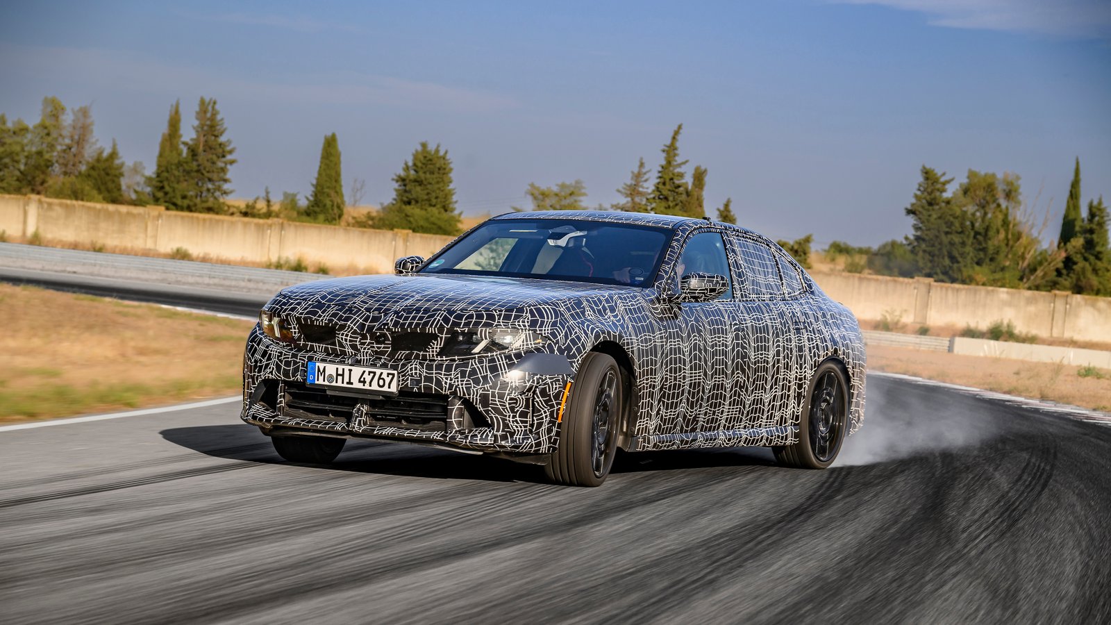 BMW M350 xDrive prototype drifting with rear tires smoking at Miramas