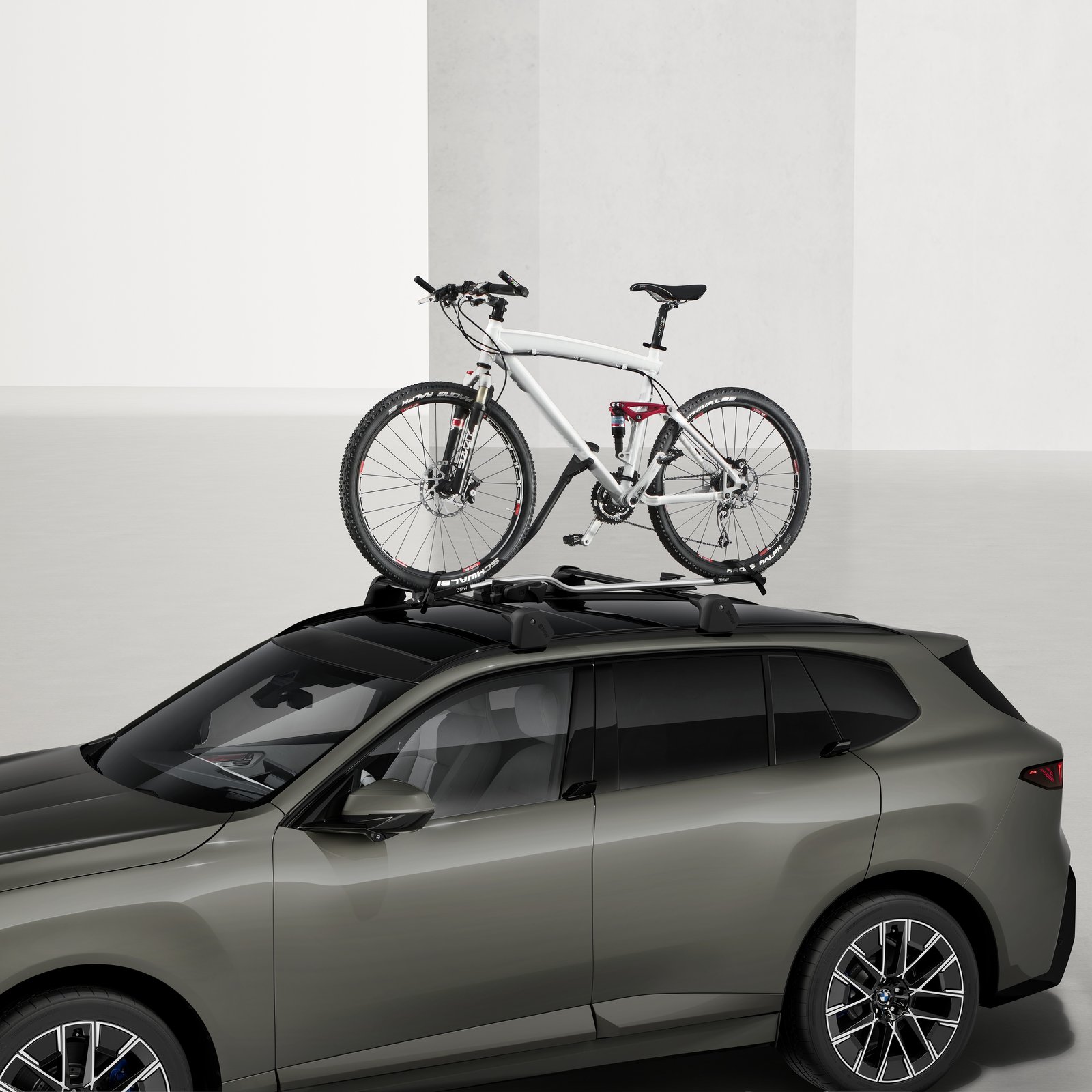 Open BMW Aero roof box packed with four BMW luggage bags