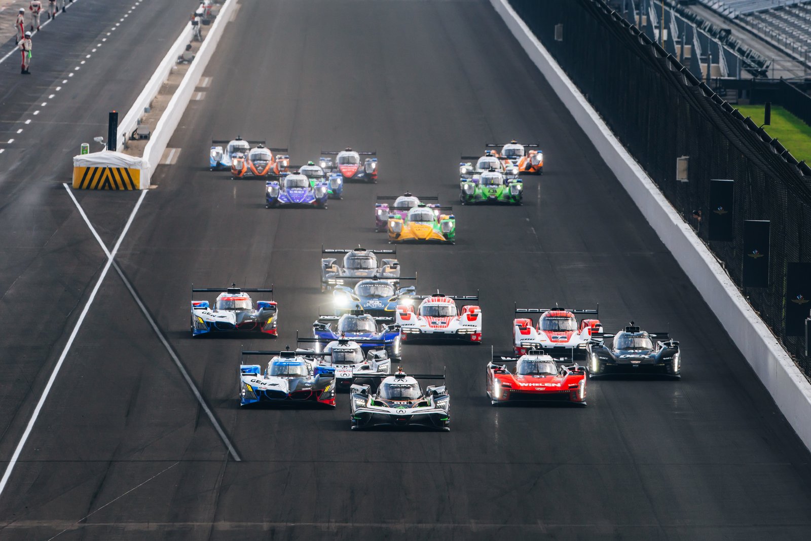 GTP field charging toward Turn 1 at the start at Indianapolis