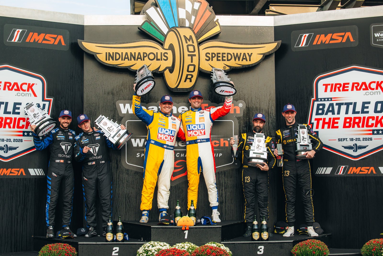 Robby Foley and Patrick Gallagher celebrating on the GTD podium at Indianapolis