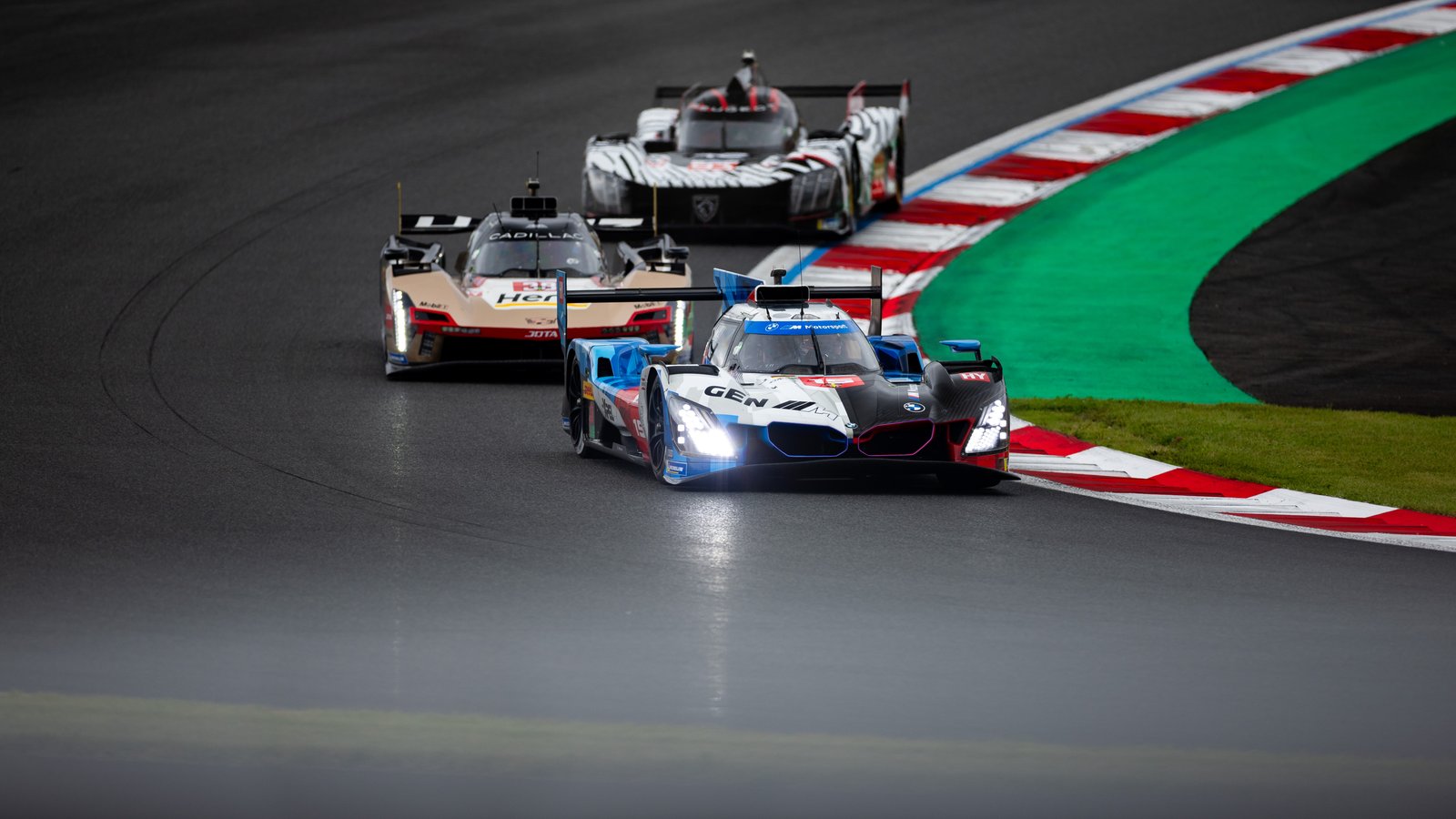 Red No. 32 BMW M4 GT3 EVO clips a curb at Fuji